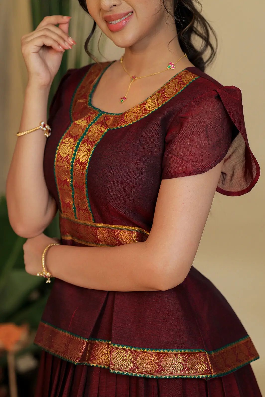 Close-up of red handloom lehenga with intricate gold detailing