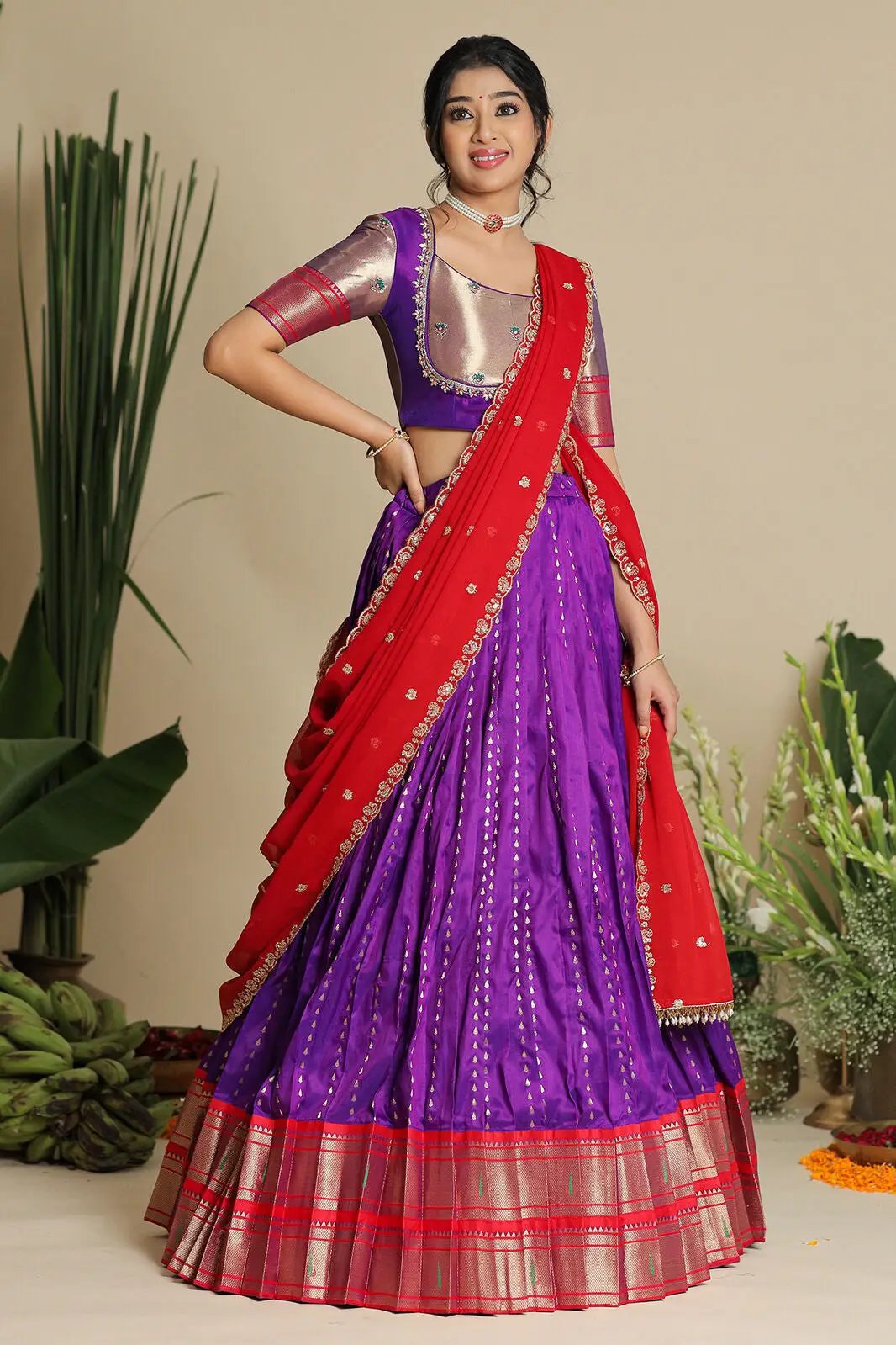 Traditional purple lehenga with red dupatta, standing pose