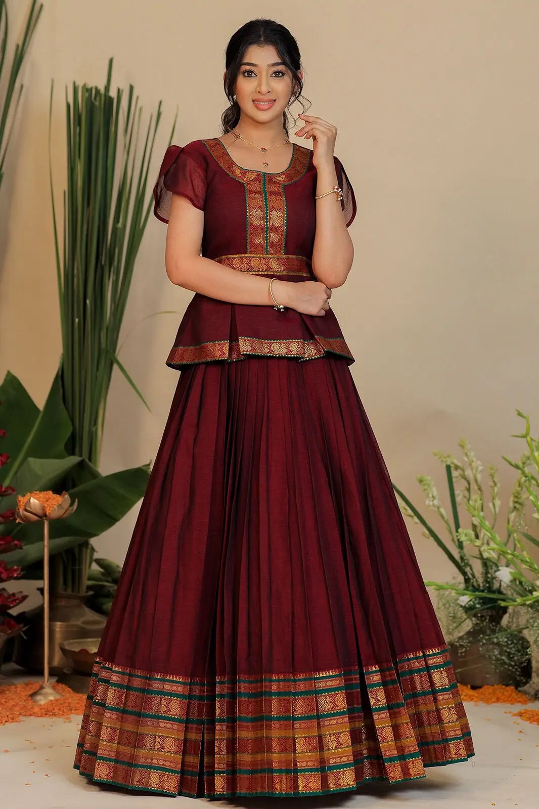 Traditional red lehenga with gold border and detailed blouse