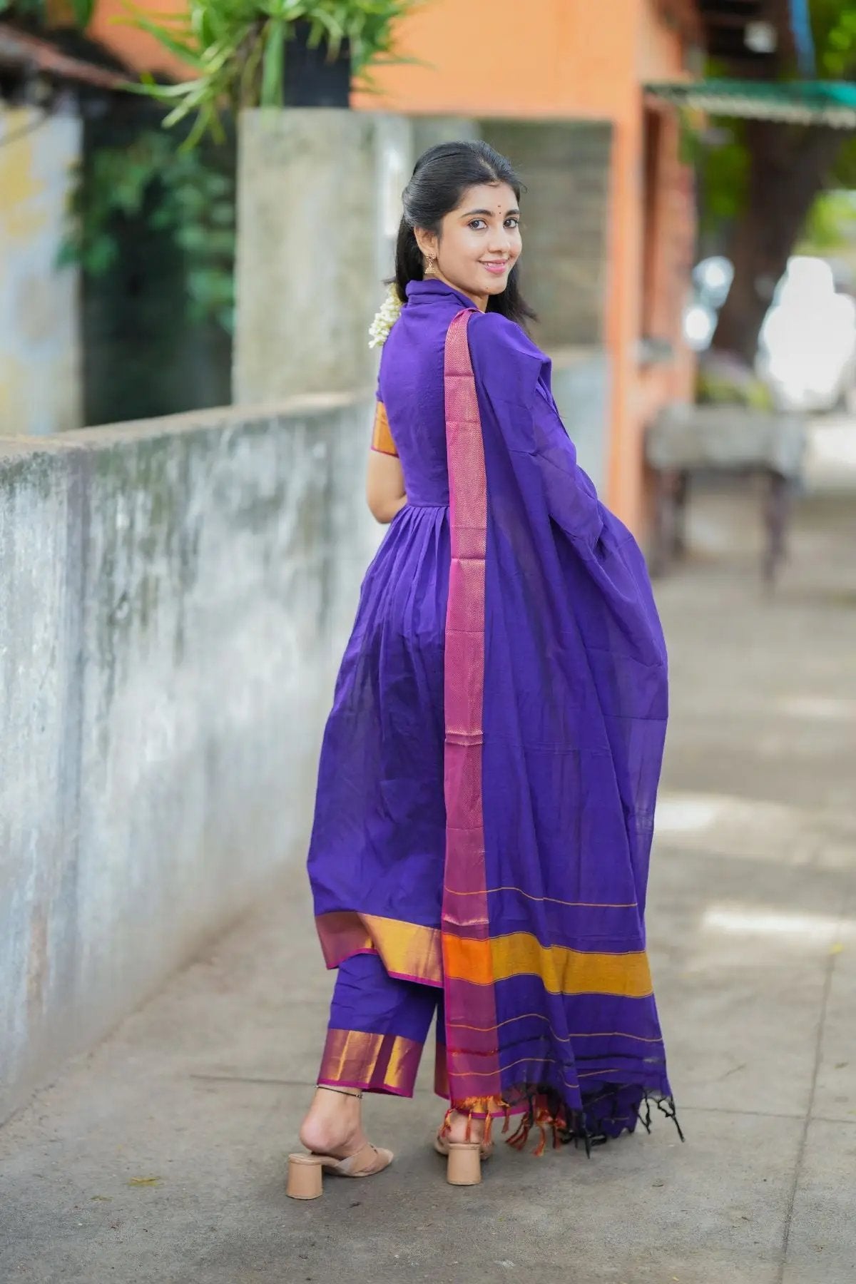 Back view of purple handloom suit set with golden trim