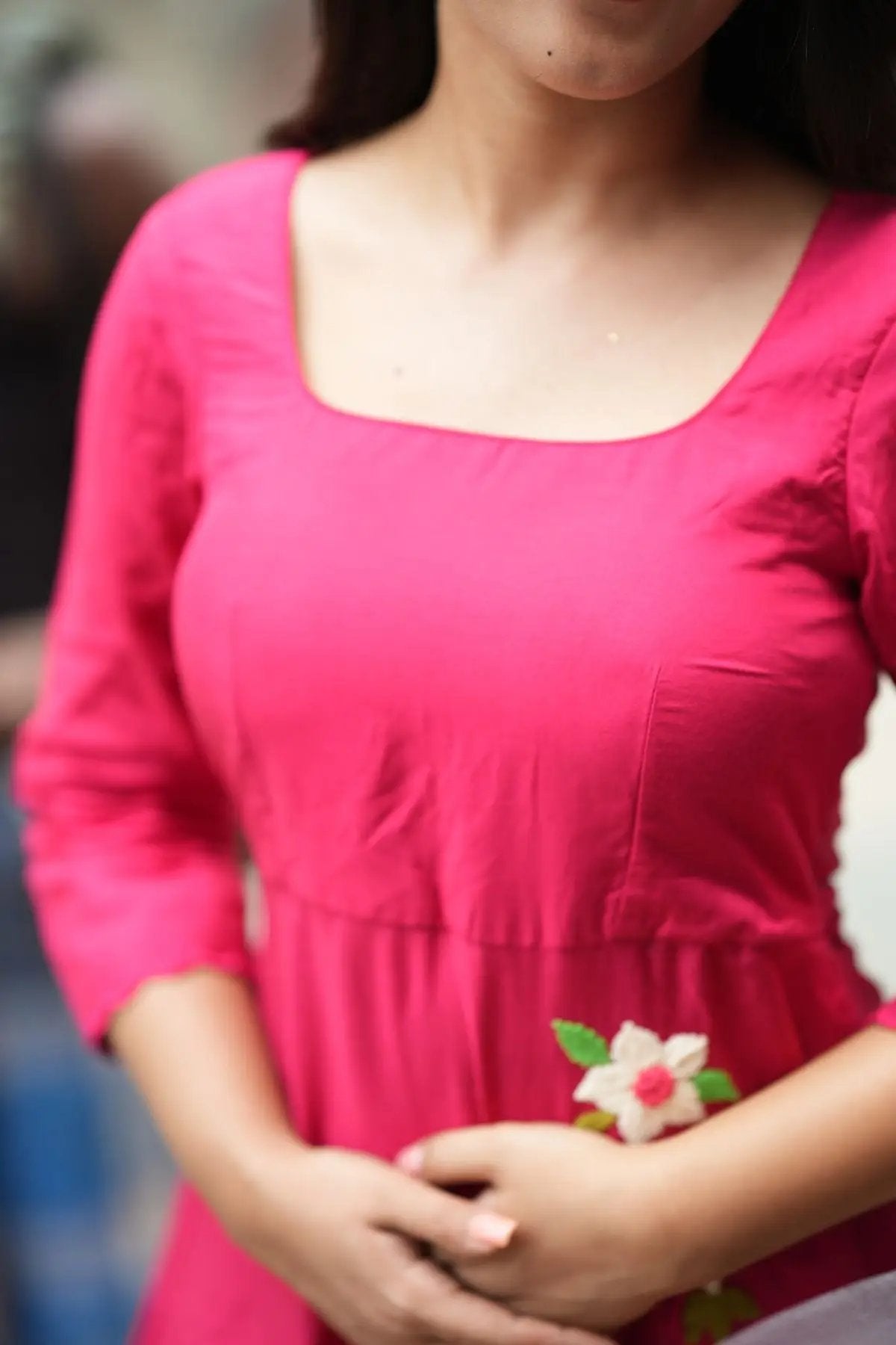 Close-up of the Rasha Kurta Set in Raspberry, showcasing intricate floral embroidery and a flattering square neckline for a stylish look.