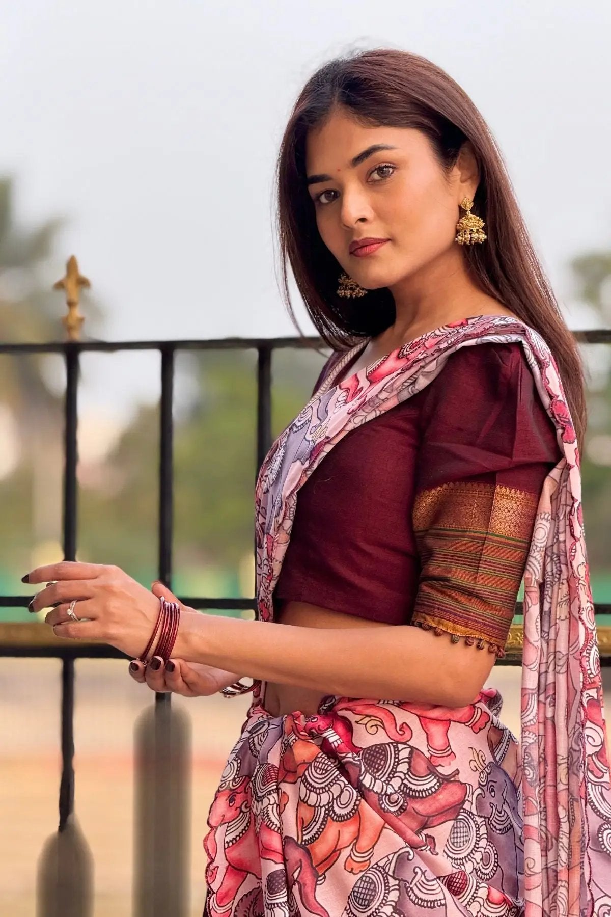 Saumya Handloom Lehenga Set in maroon with a focus on the blouse's intricate sleeve design and floral printed dupatta.