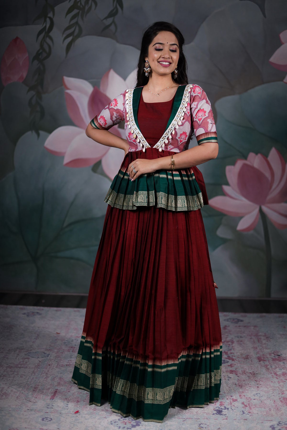 a woman in maroon pattu dress