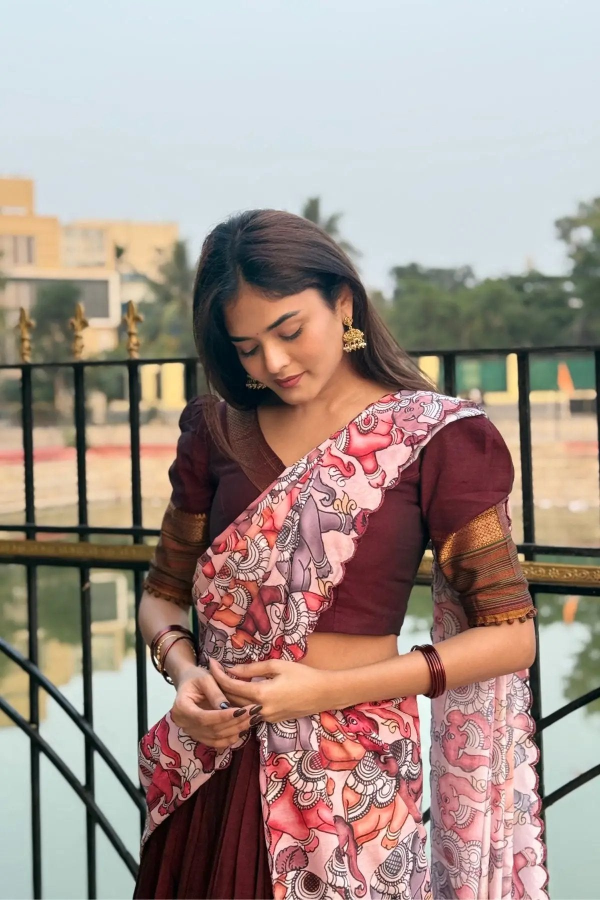 Saumya Handloom Lehenga Set in maroon with a detailed view of the floral dupatta and golden accents, styled for a festive occasion.