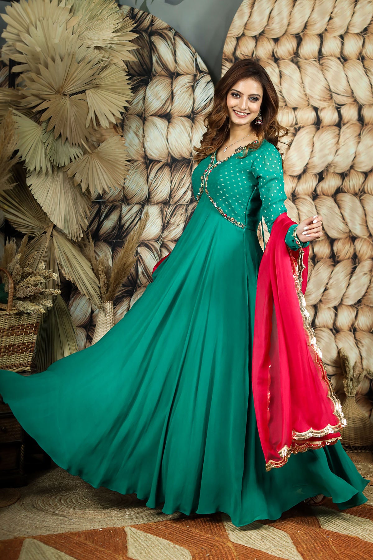 a woman in green organza dress and red dupatta
