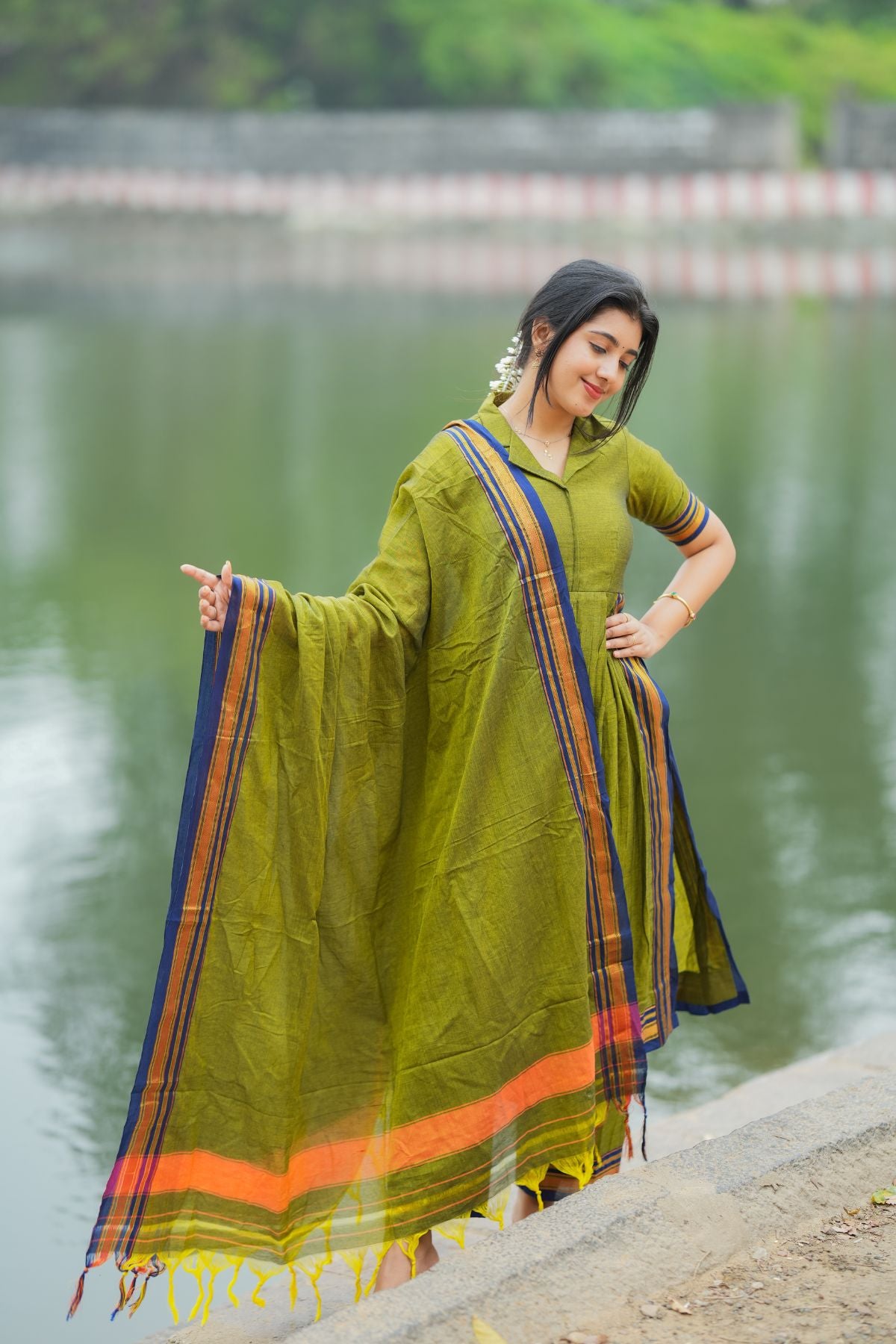 Syahi Handloom Suit Set in olive green with a flowing dupatta and intricate striped accents. A must-have ethnic wear collection at bullionknot.