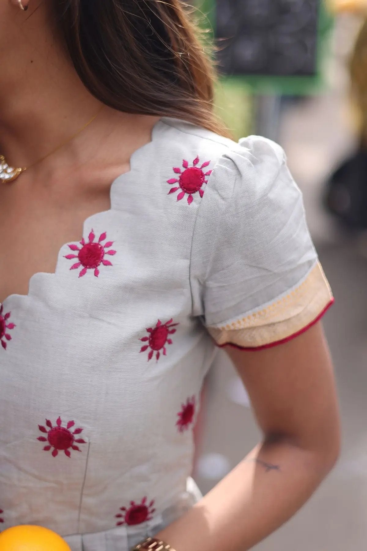 Close-up of Kalki Handloom Kurta Set in Grey, showcasing intricate red floral embroidery and scalloped neckline for an elegant ethnic look.