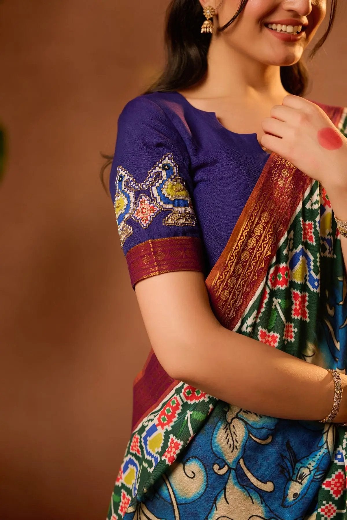 Close-up of Shloka Kalamkari Lehenga Set in Blue, showcasing detailed embroidery on the blouse sleeve.