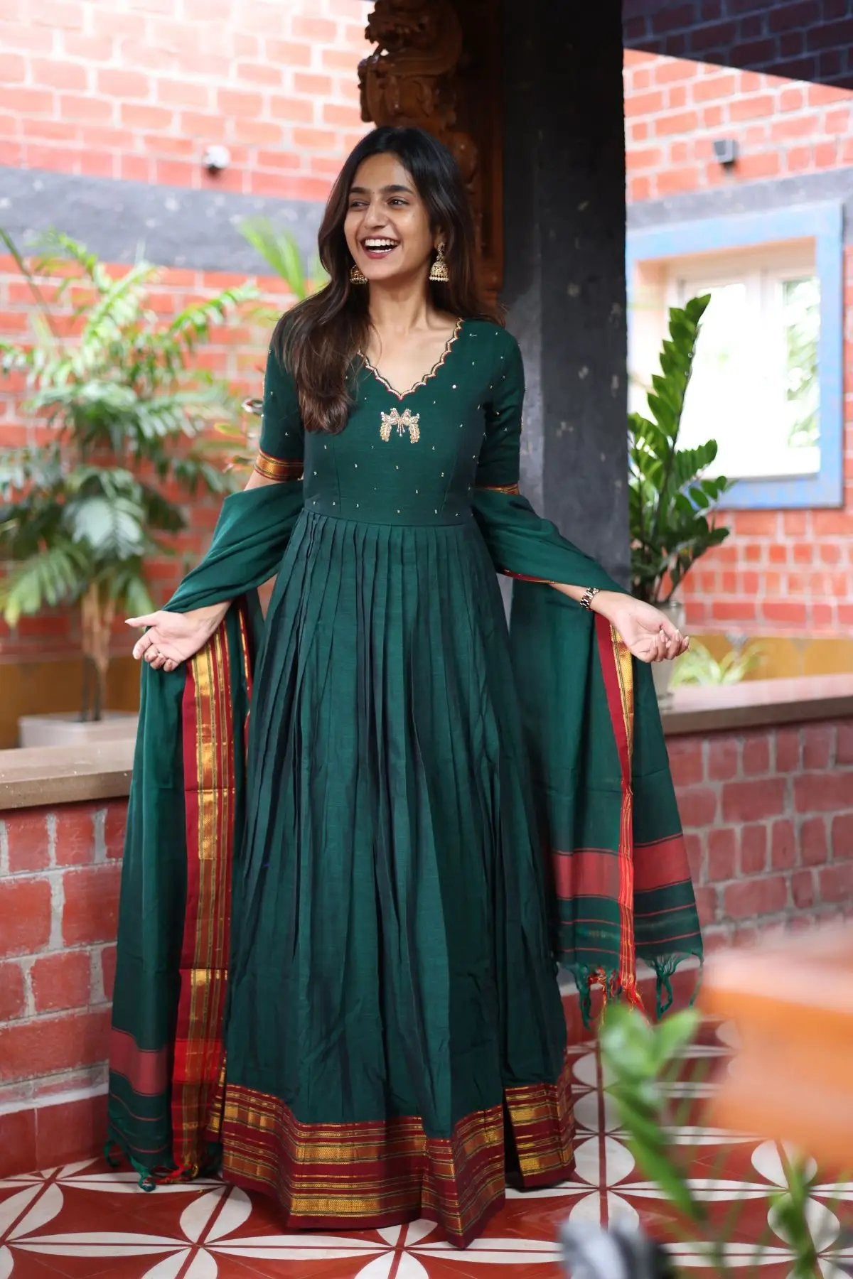 Elegant Bunaai Handloom Anarkali Dress in green with intricate embroidery and traditional detailing, perfect for festive and ceremonial occasions.