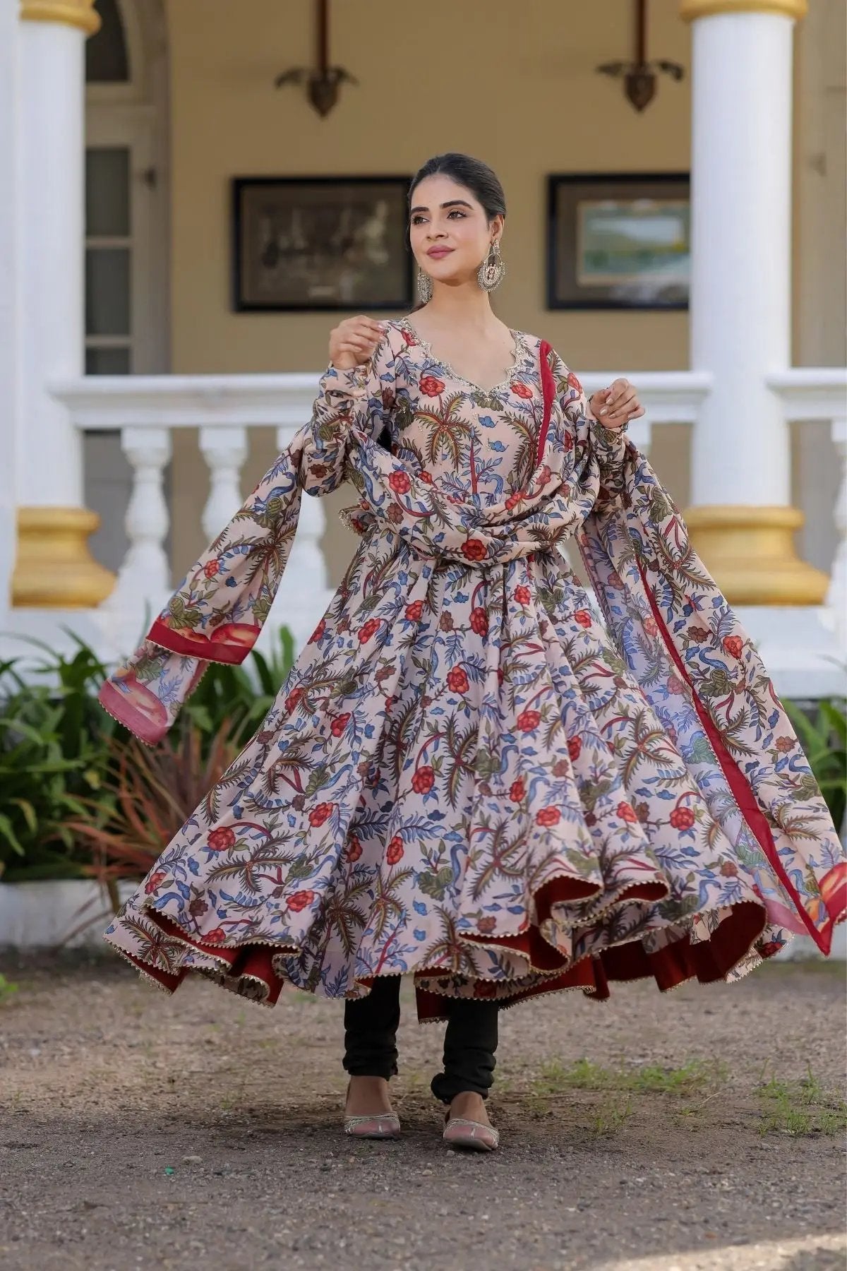 Mihika Anarkali dress in beige, twirling view with red accents