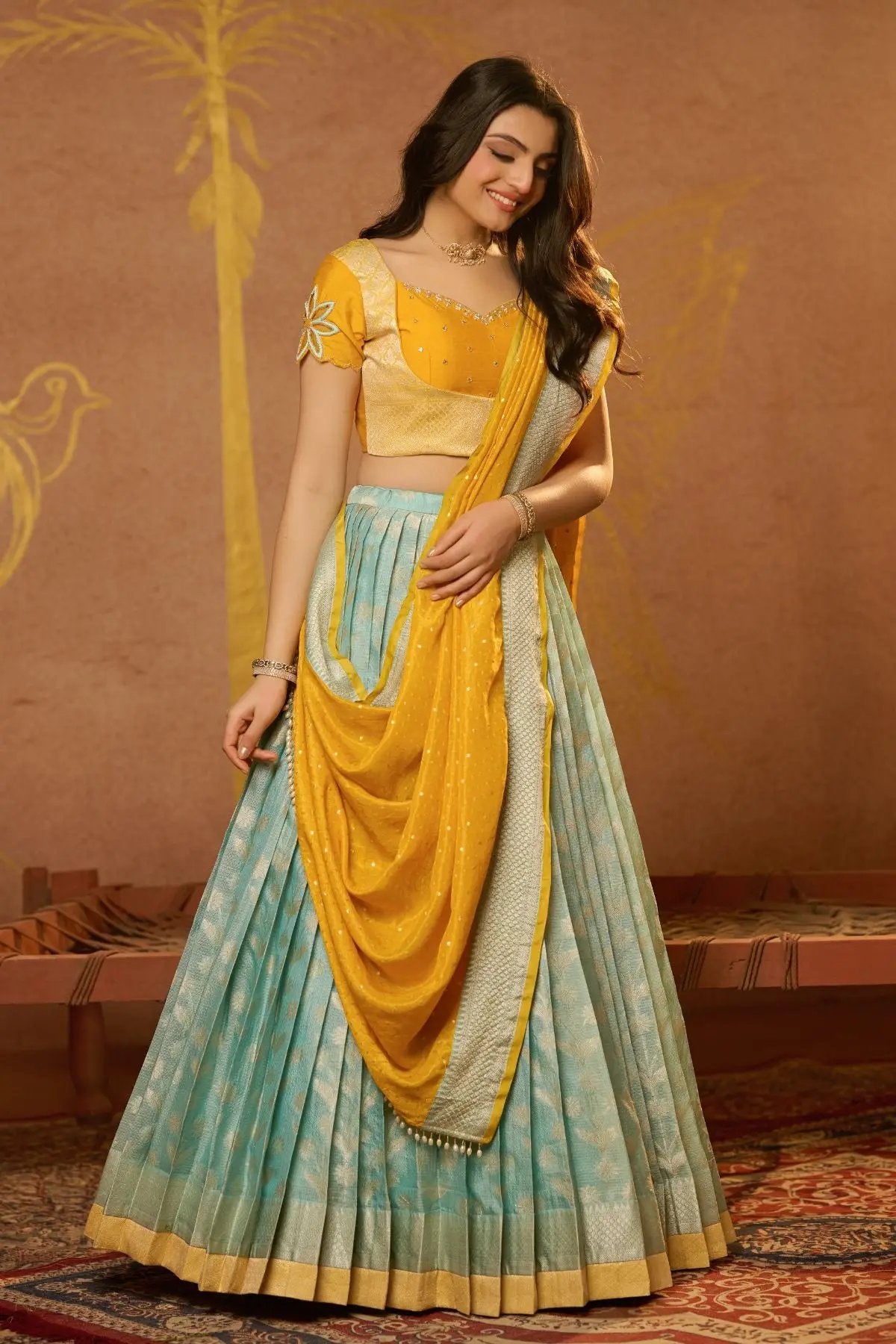 Graceful Aadhya Lehenga Set in Yellow with a vibrant blue skirt and embroidered blouse, perfect for celebrations. Shop now at bullionknot.