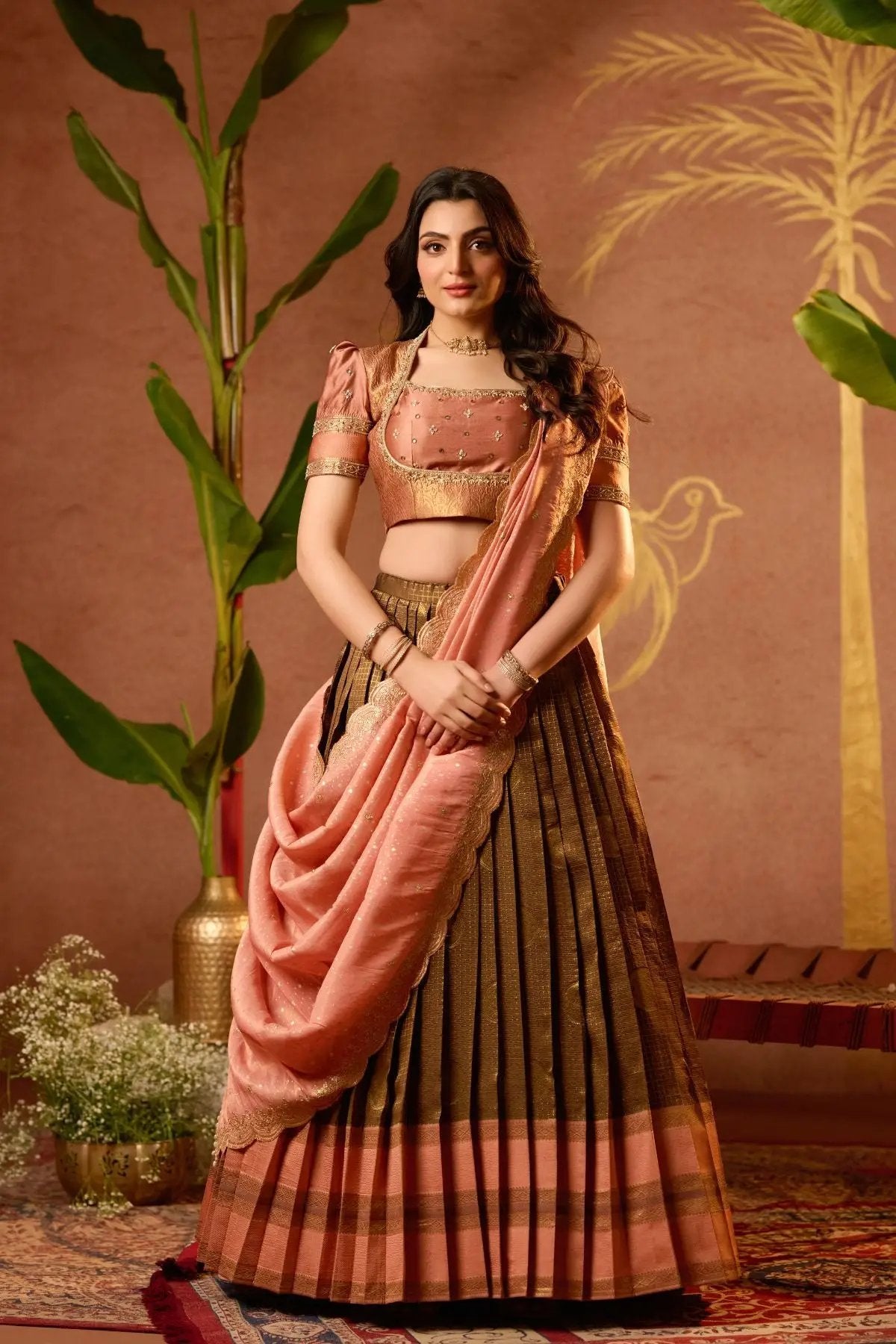 Exclusive Tamannaah Lehenga Set in Copper with intricate mirror work, cutdana neckline, and scalloped dupatta. Perfect for weddings and festive occasions.