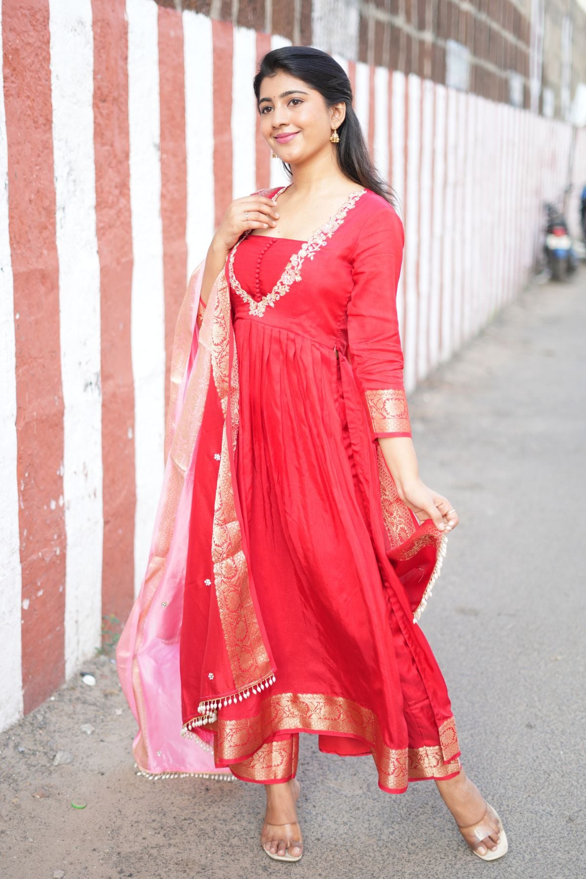 Full-length view of Madhubala Silk Kurta Set in Red, highlighting its pleated design and golden Banarasi border. A stunning ethnic dress for festive occasions.