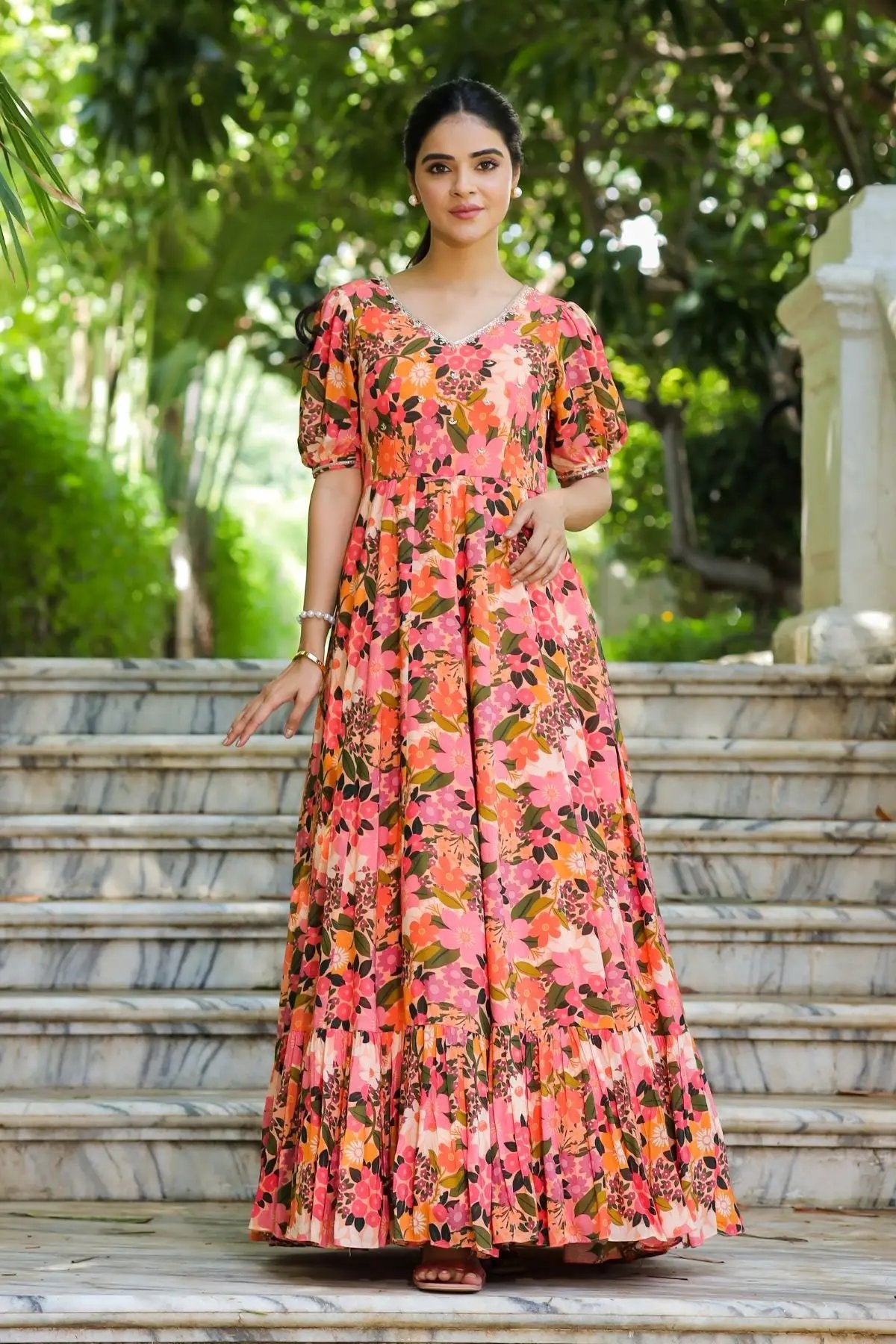 Model wearing the Gulmohar Maxi Dress in Peach, featuring a flowy silhouette, puff sleeves, and a flattering V-neckline with handwork detailing.