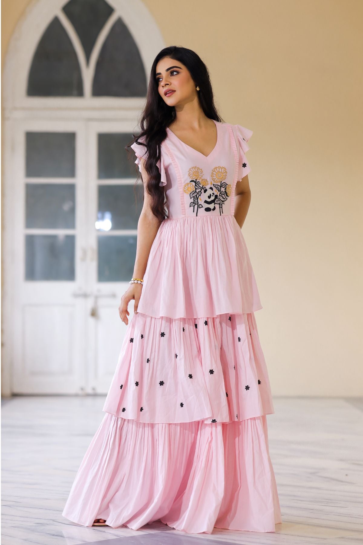 Charming pink maxi dress featuring ruffled sleeves and floral design