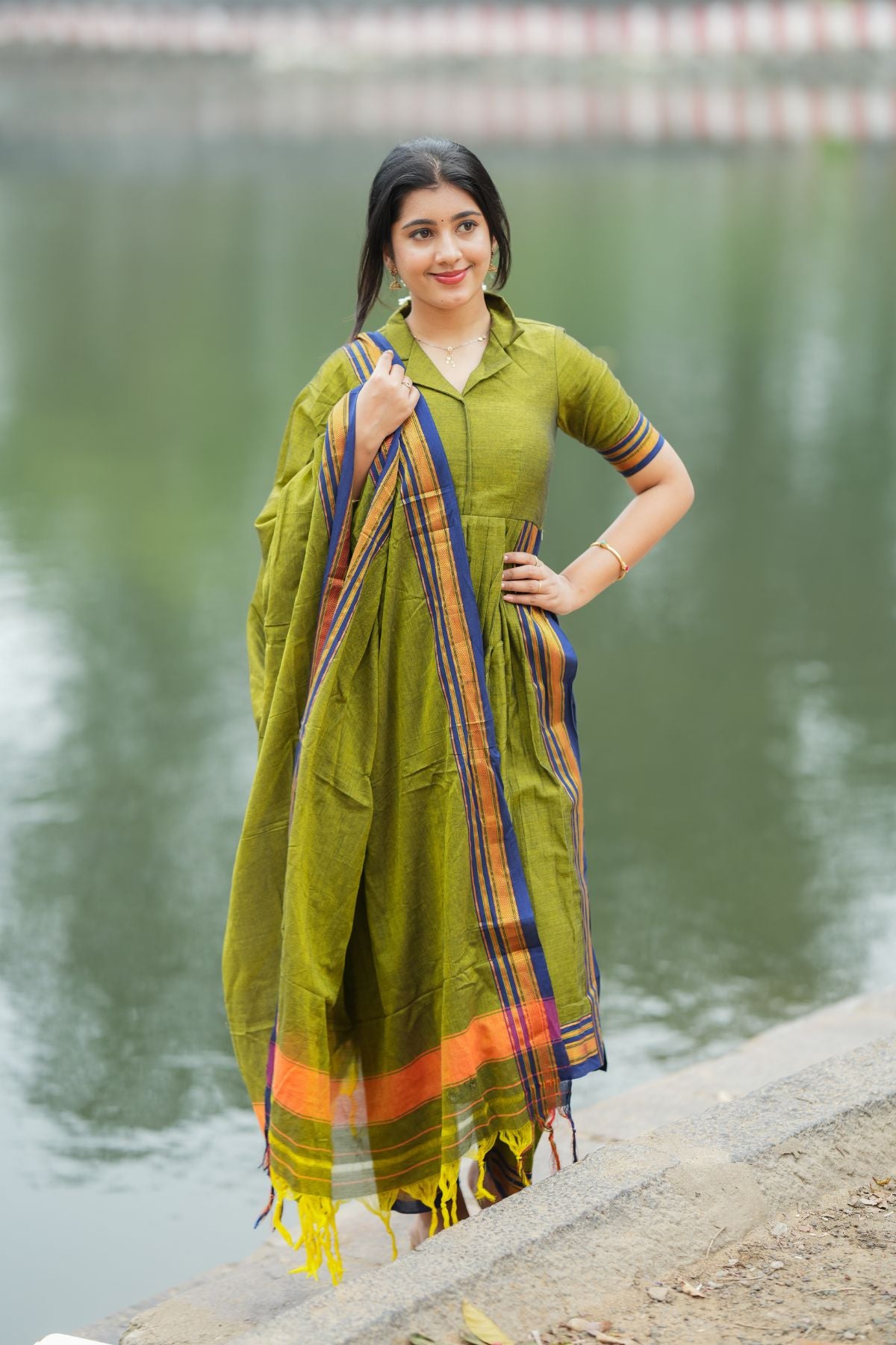 Syahi Handloom Suit Set in olive green with intricate striped detailing, featuring a flared kurta, matching pants, and a dupatta. Available at bullionknot.