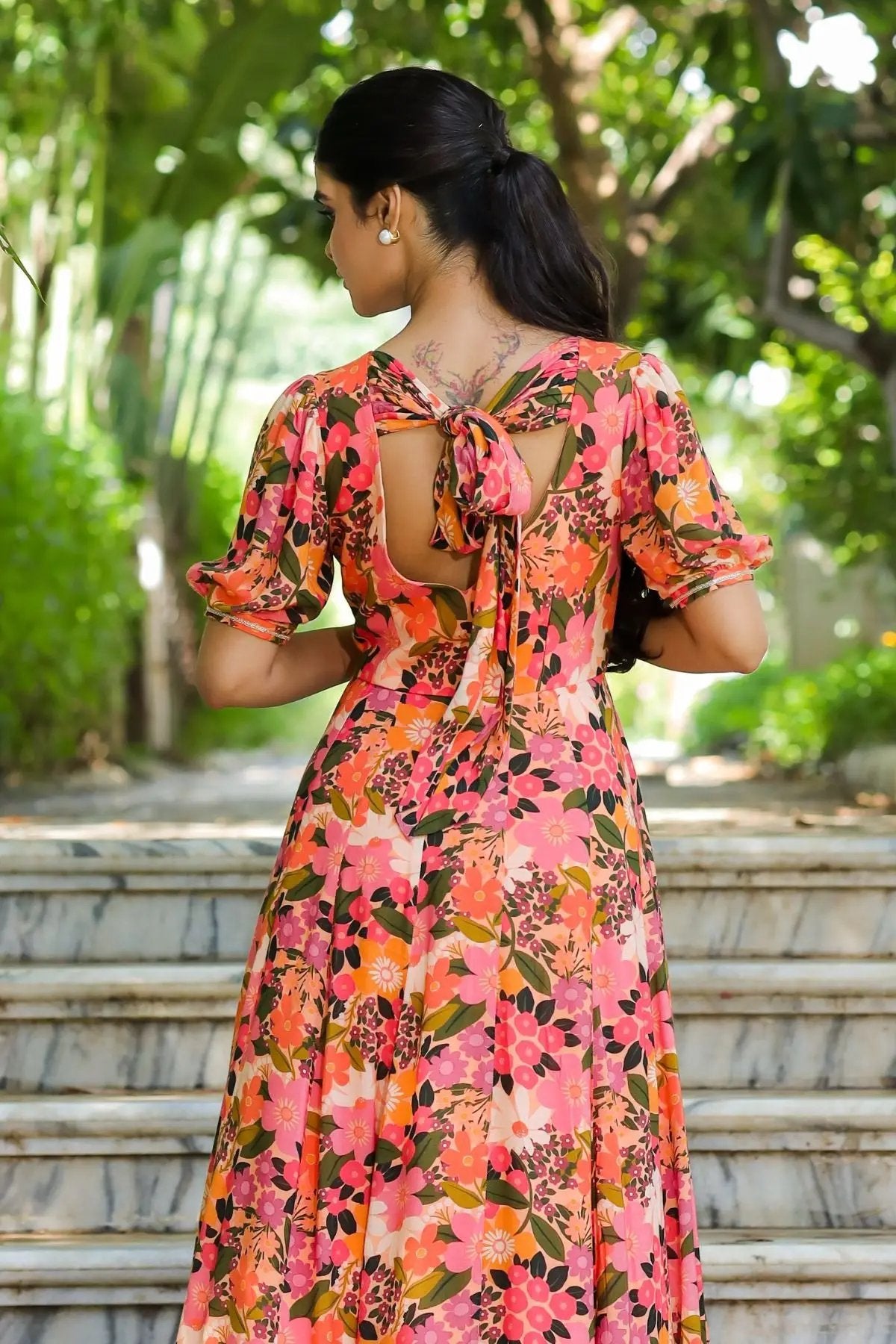 Back view of the Gulmohar Maxi Dress in Peach, featuring a stylish tie-up bow and open-back design, adding a modern touch to ethnic wear.