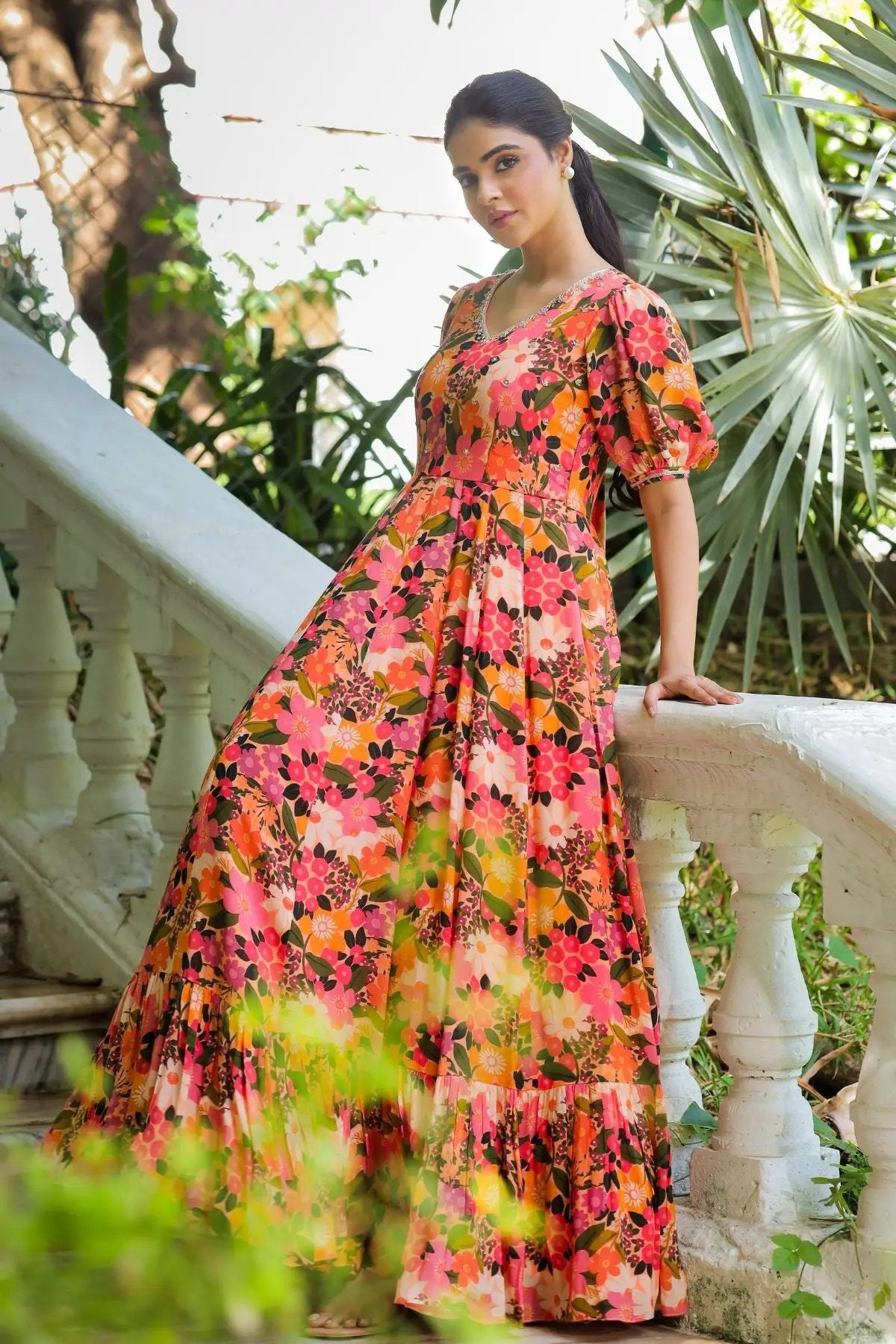 Graceful pose in the Gulmohar Maxi Dress in Peach, highlighting its elegant floral design, puff sleeves, and flowing skirt for a timeless ethnic look.