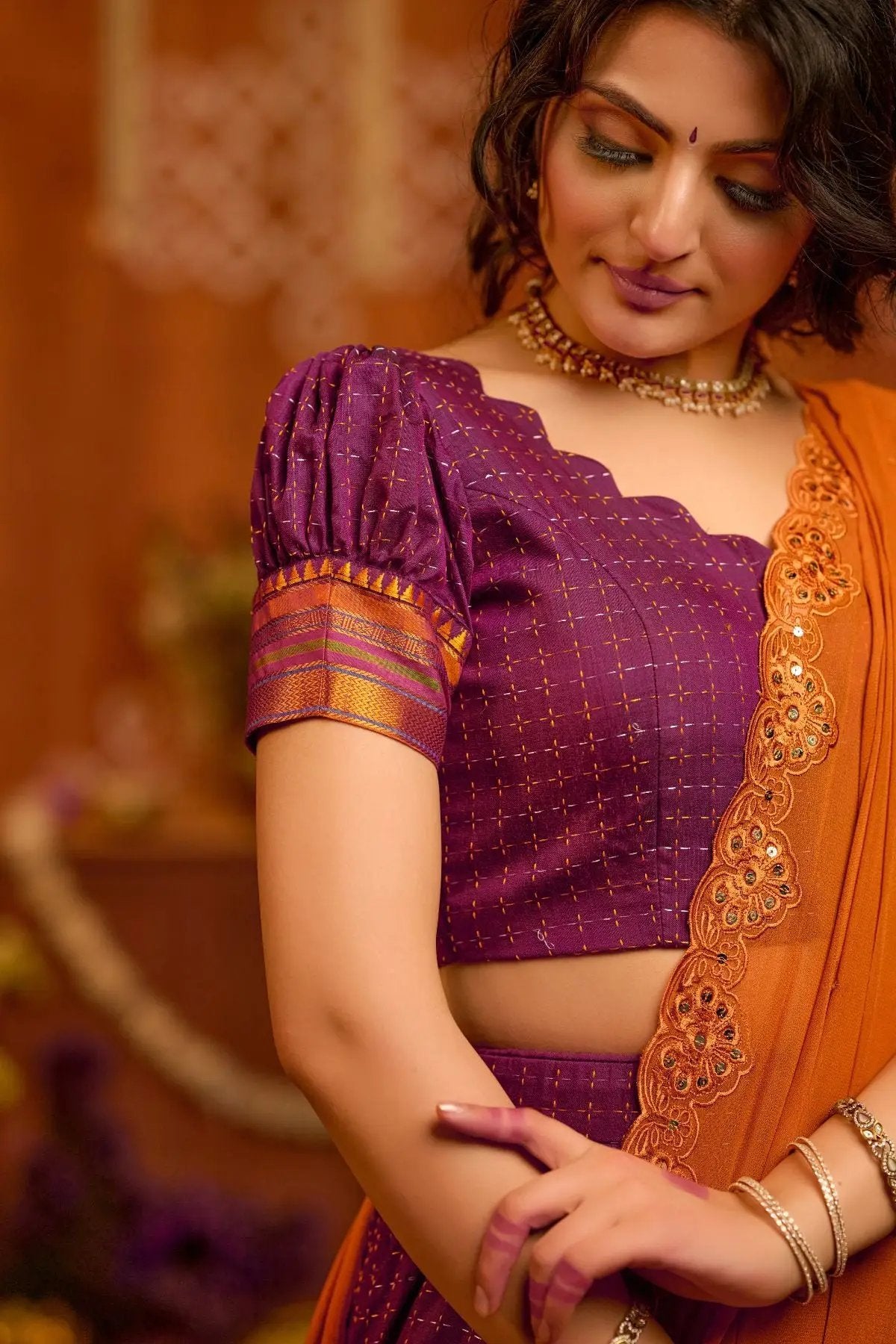 Close-up of Vairagi Naraynpet Lehenga Set in purple, showcasing detailed embroidery, puffed sleeves, and elegant gold accents.