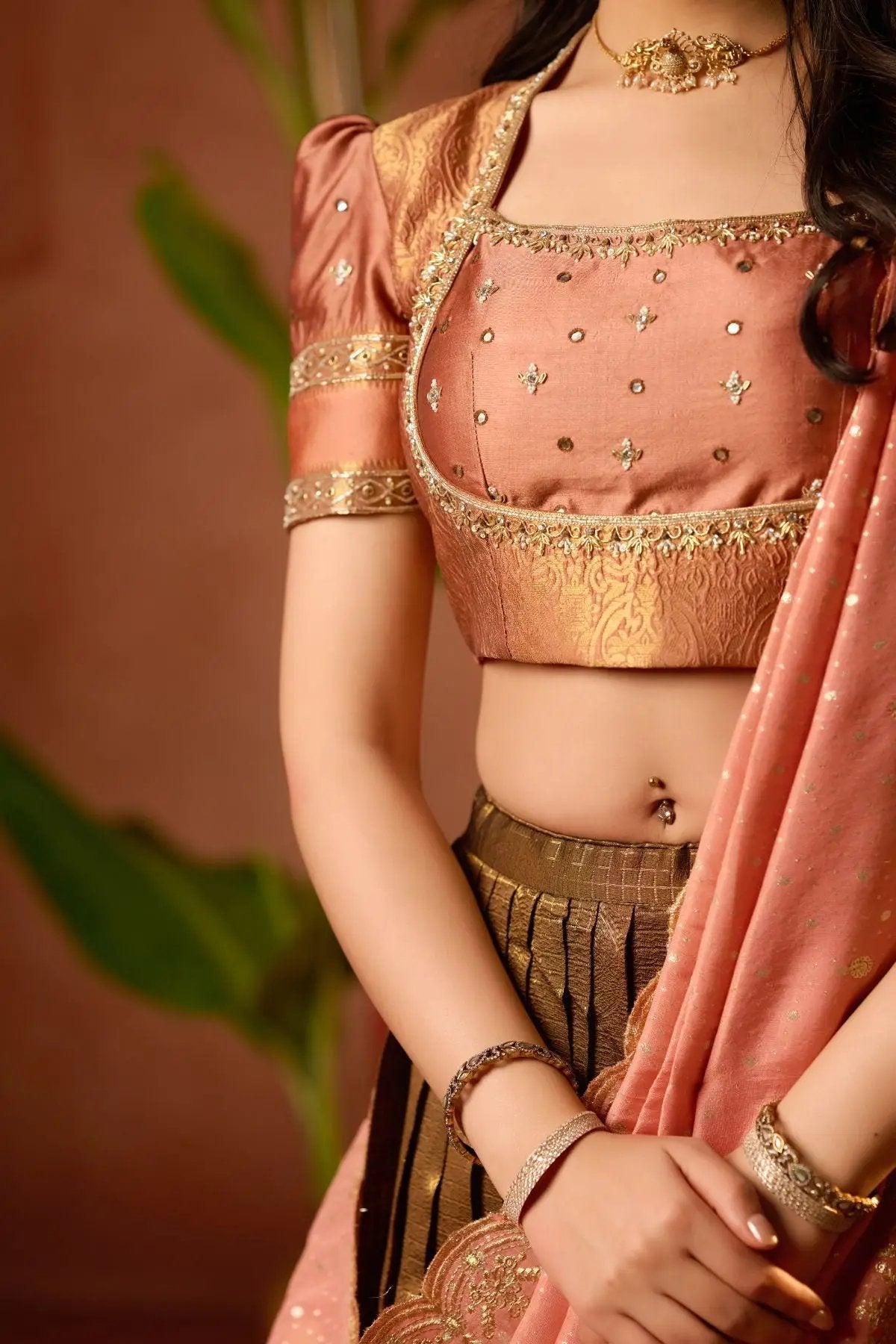 Close-up of Tamannaah Lehenga Set in Copper featuring delicate embroidery, puffy sleeves, and elegant detailing. A stunning choice for traditional events.