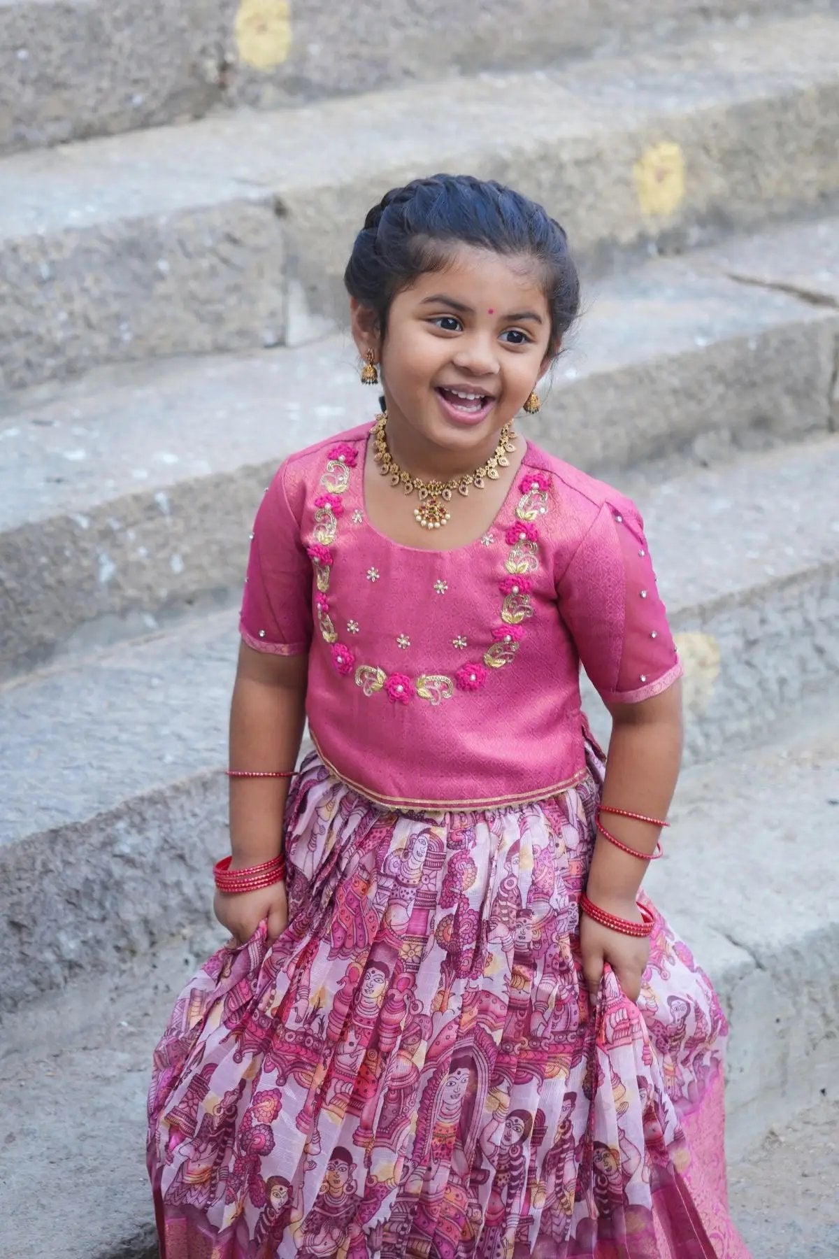 Festive Baby Saanvi Lehenga Set in Pink, a beautifully crafted kids' outfit with intricate embroidery and a pleated skirt, ideal for cultural events.