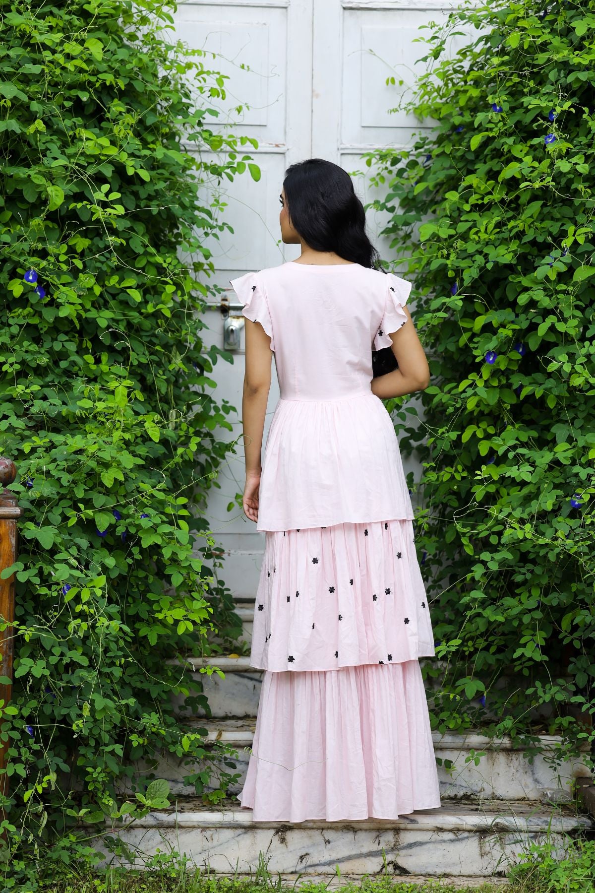 Back view of pink maxi dress with tiered skirt and ruffled sleeves