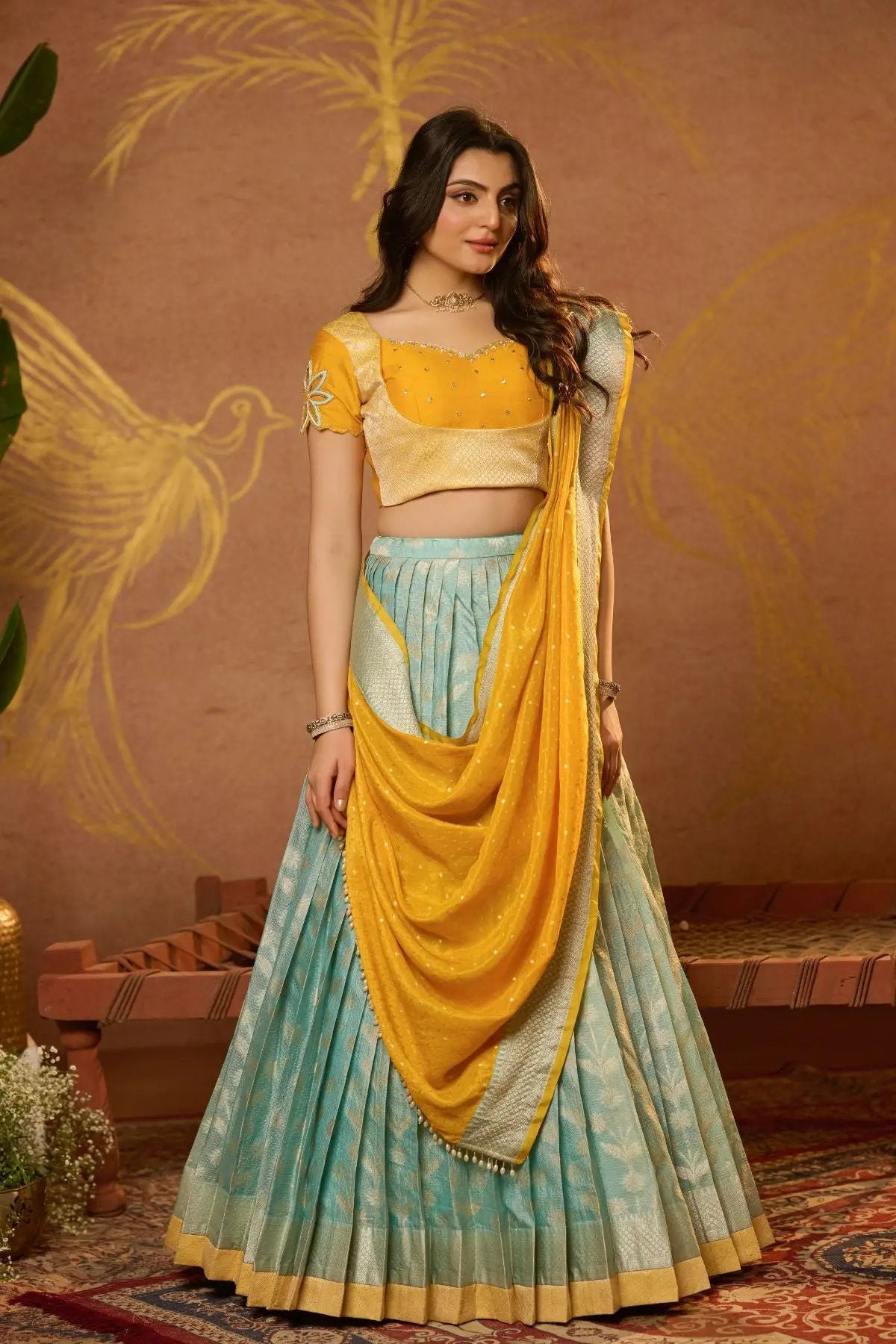 Traditional Aadhya Lehenga Set in Yellow with a stunning combination of blue and gold, ideal for festive occasions. Available at bullionknot.