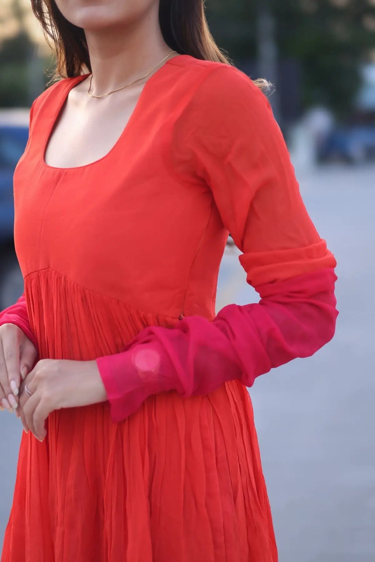 Close-up of the Aura Palazzo Set in Orange, showcasing its elegant fabric, long sleeves, and gradient color transition.