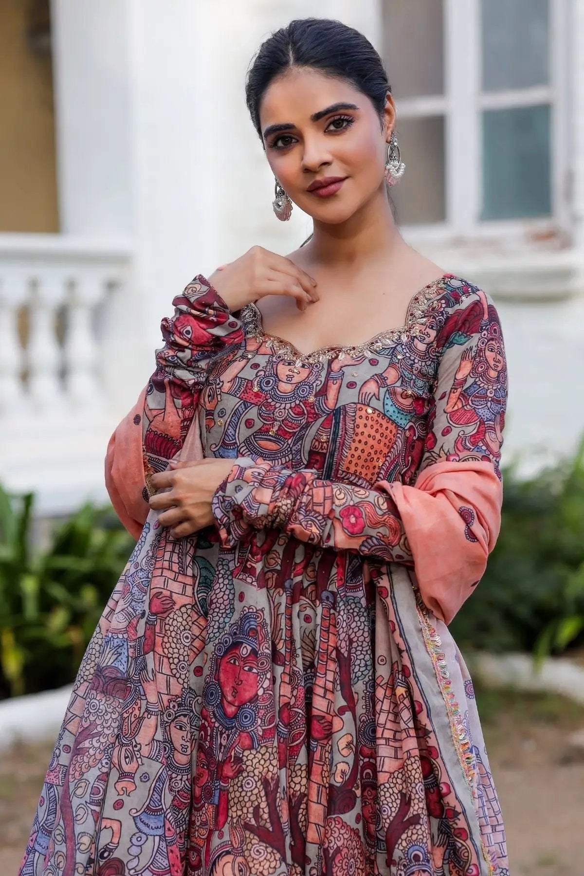 Model wearing maroon Kuhu Anarkali with artistic motifs