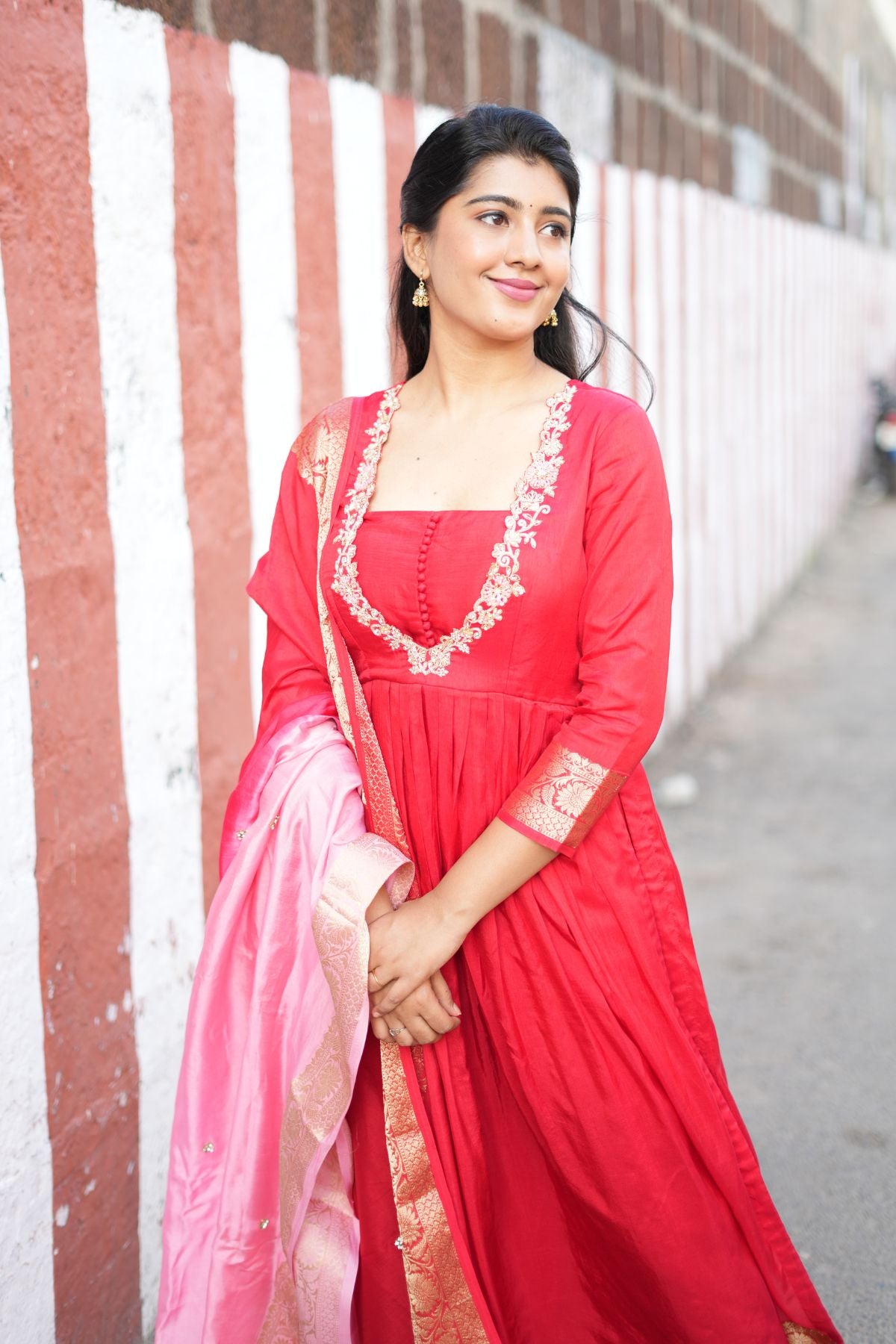 Model in Madhubala Silk Kurta Set in Red, styled with a pink Banarasi dupatta. A sophisticated ethnic dress perfect for weddings and festive gatherings.