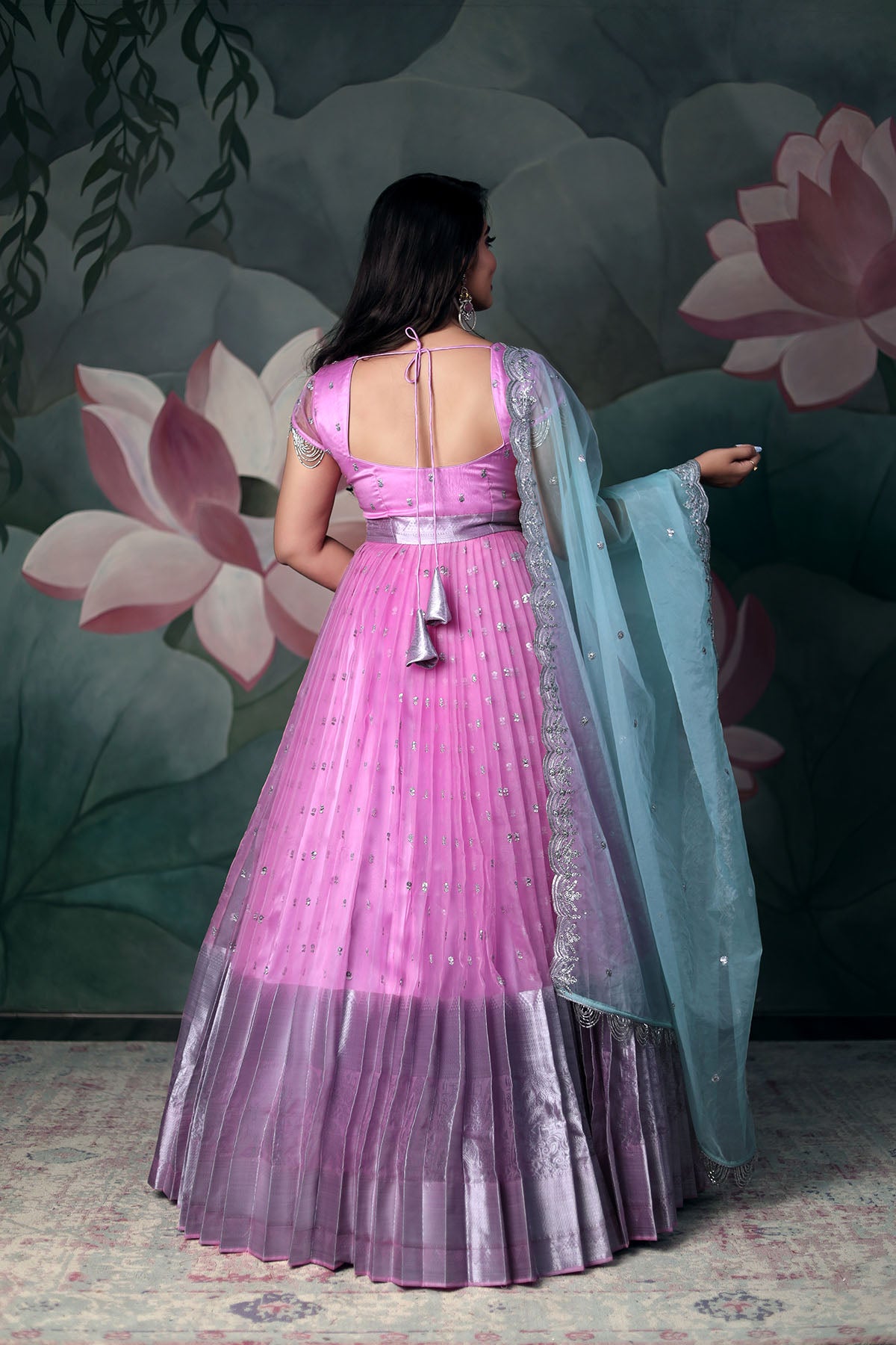 A model in pink Organza anarkali dress with blue dupatta