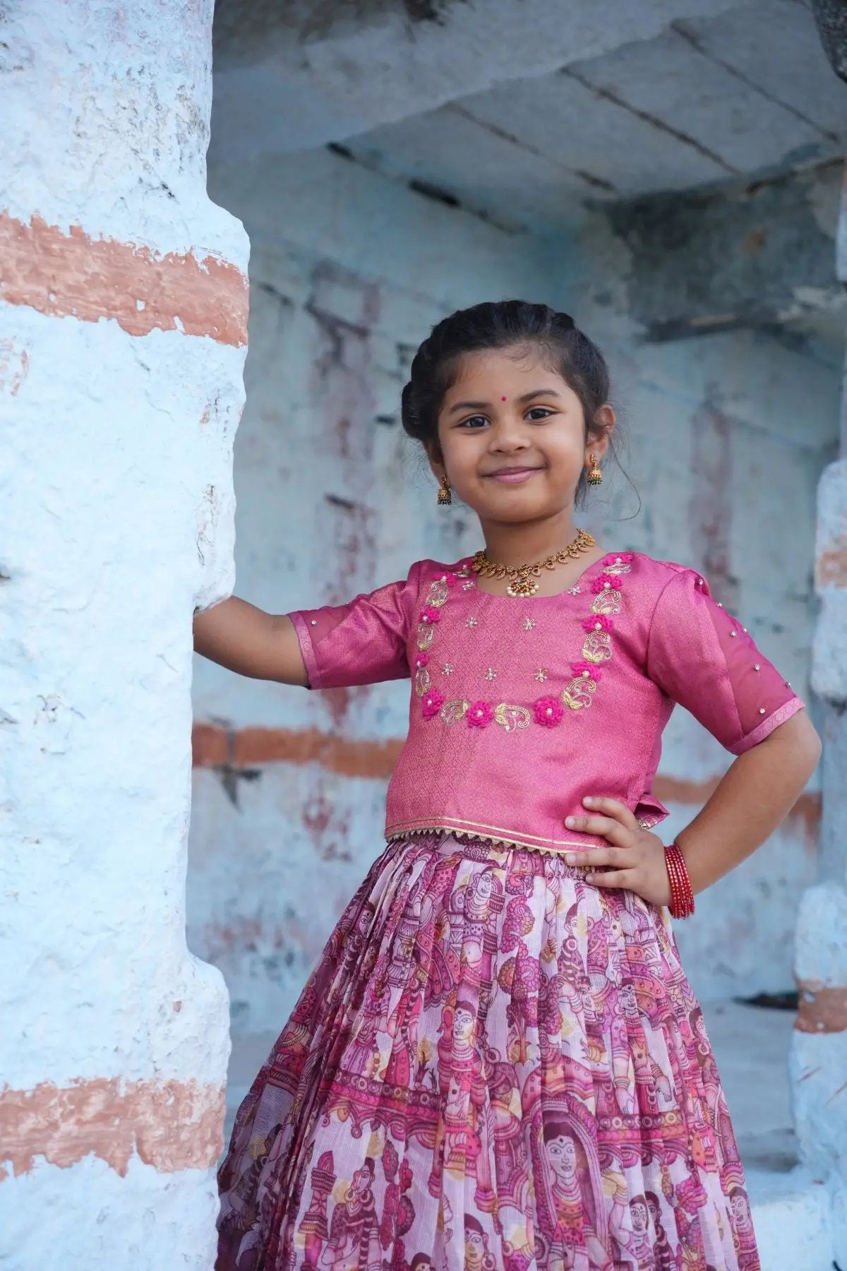 Elegant Baby Saanvi Lehenga Set in Pink, a stylish ethnic outfit for kids with a beautifully embroidered blouse and vibrant pleated skirt.