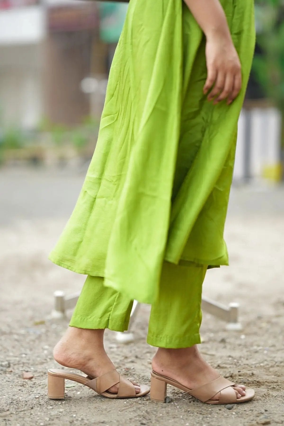 Close-up of the hemline and pants of the Sundar Kurta Set in Green, paired with nude block heels. A chic and comfortable ethnic outfit.