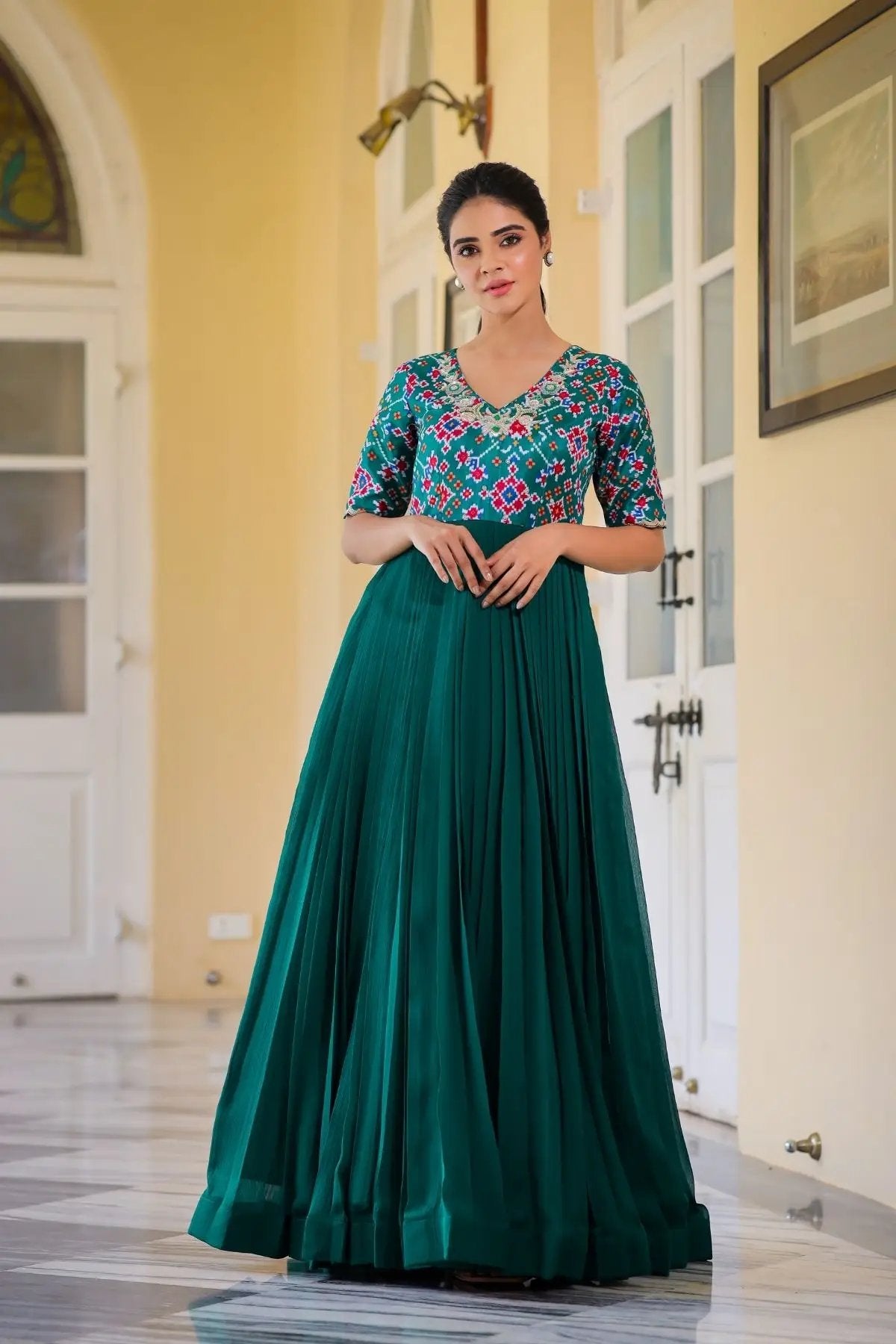 Gehna Patola Maxi Dress in Green featuring a pleated long skirt and embroidered patterned bodice. Shop exclusive long dresses at bullionknot.