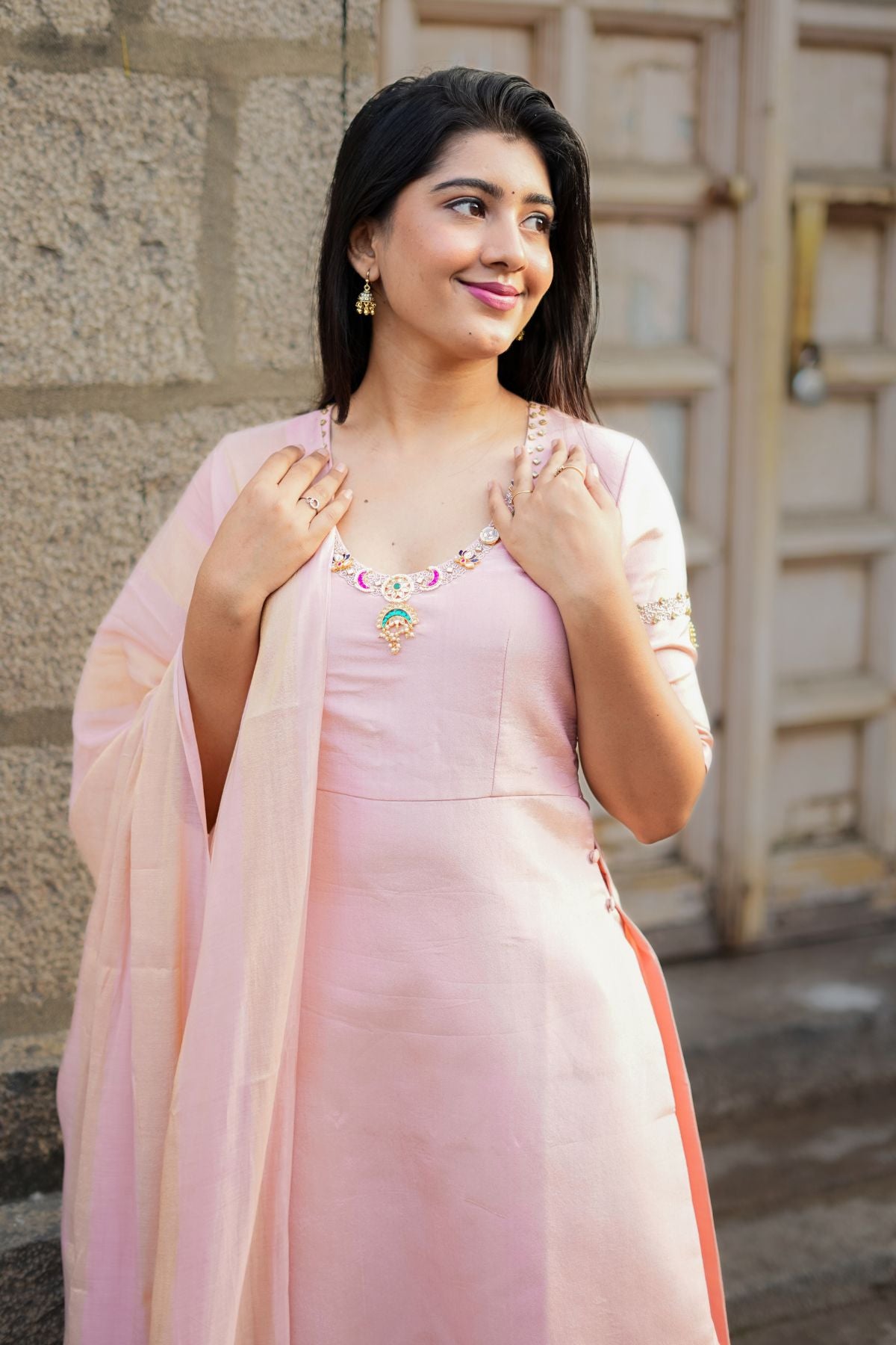 Close-up of Noor Jadau Kurta Set in peach, showcasing delicate jadau embellishments on the neckline and sleeves for an elegant look.