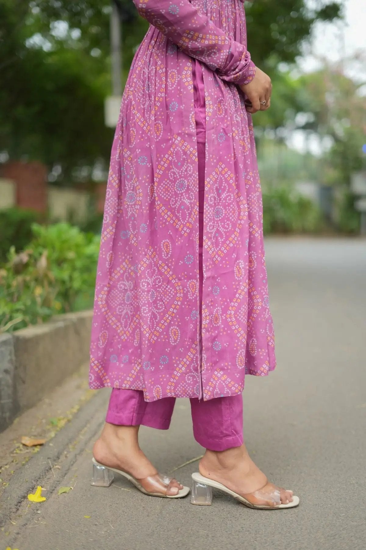 Side view of Pragati Kurta Set in Pink with a stylish slit and matching pants, paired with transparent heels for a chic traditional outfit.