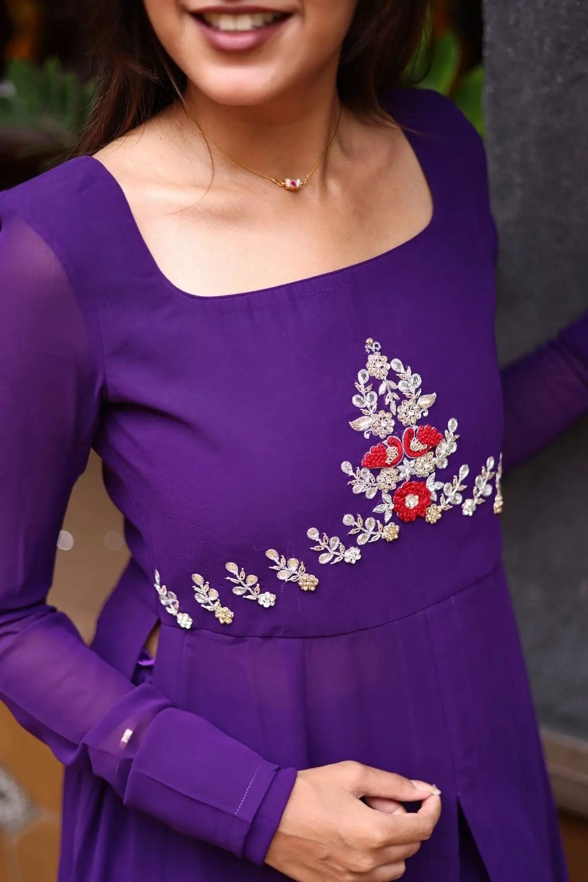 Close-up of purple kurta with intricate floral design