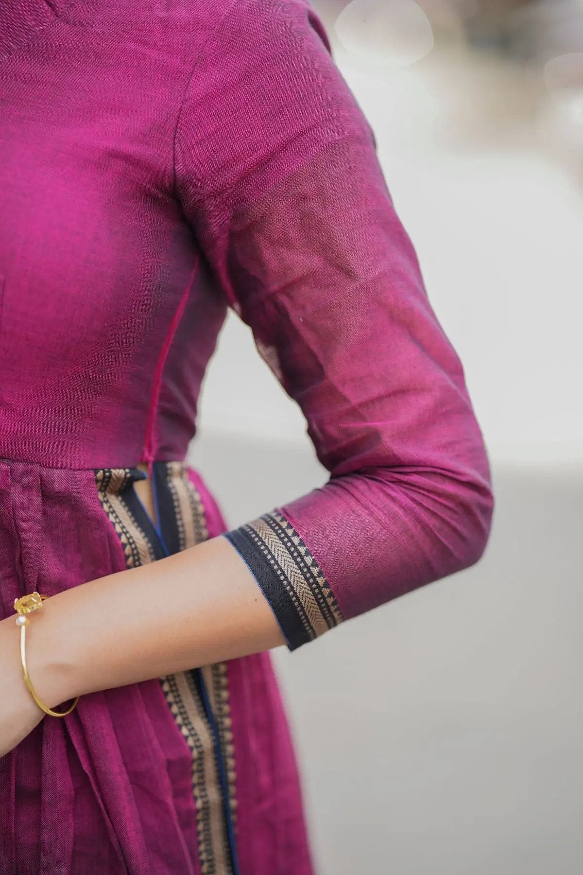 Close-up of the maroon Kasturi Handloom Kurta Set sleeve, showcasing fine fabric texture and elegant border embroidery.