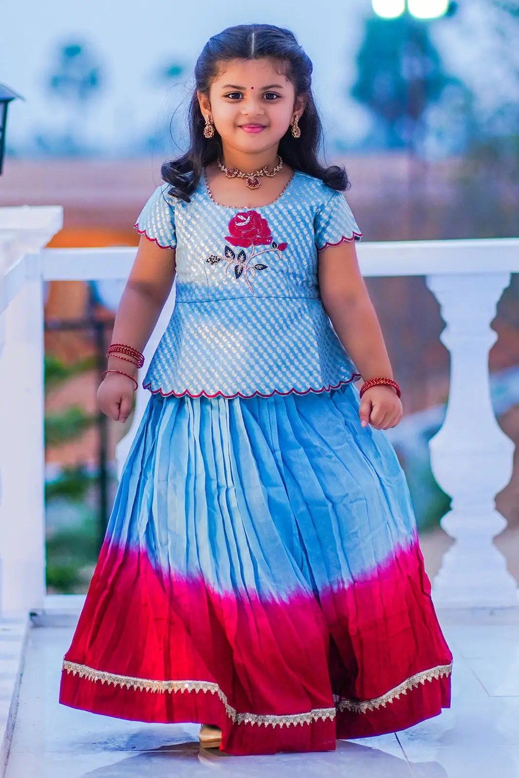 Child wearing Baby Rosy Lehenga Set in blue and red