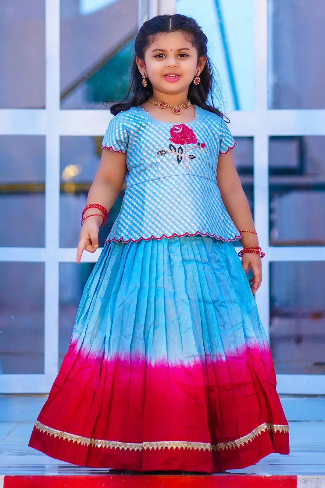 Girl in Moonstone Blue Lehenga Set with floral design