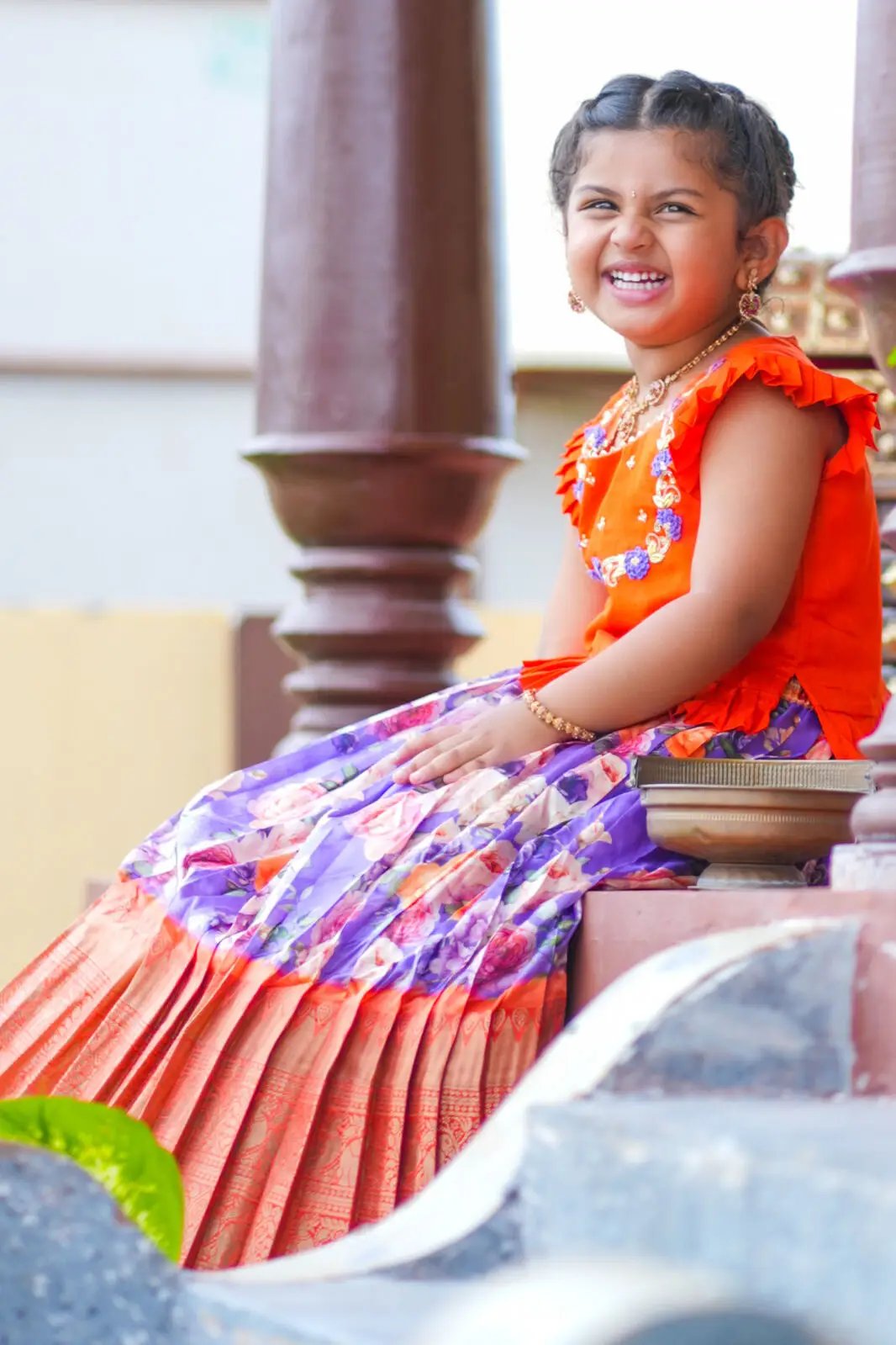 Smiling girl in Baby Blush Lehenga Set, purple and orange attire