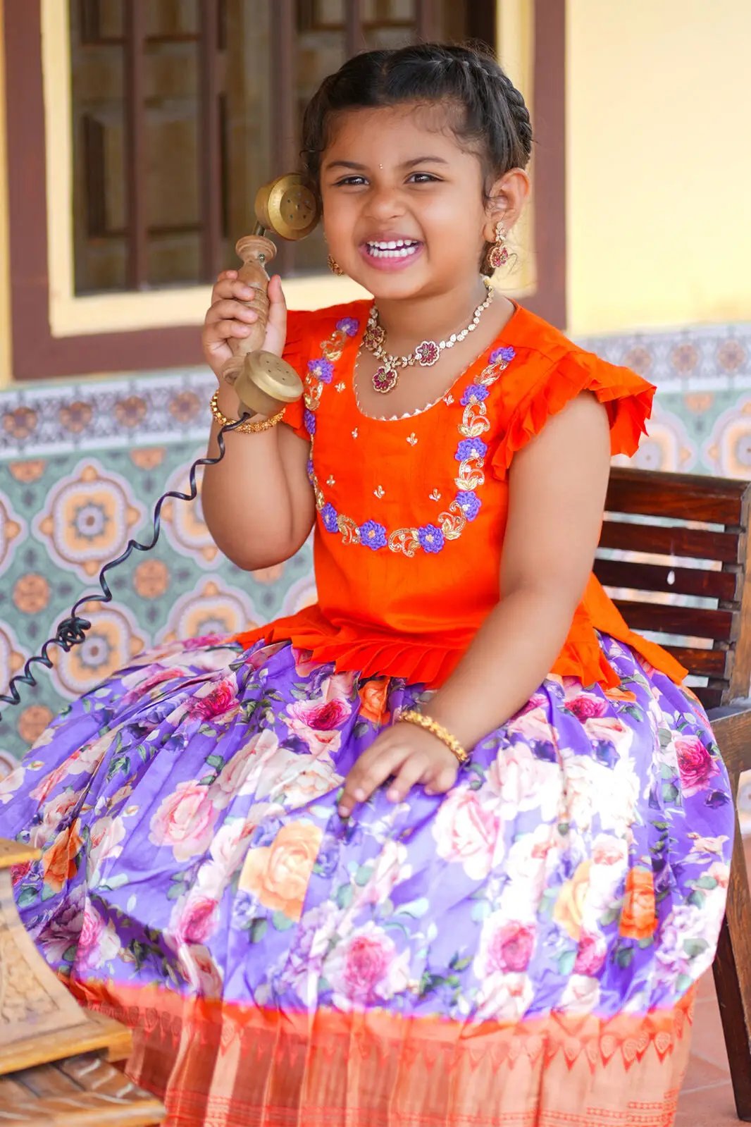 Happy child in Baby Blush Lehenga Set, colorful traditional wear