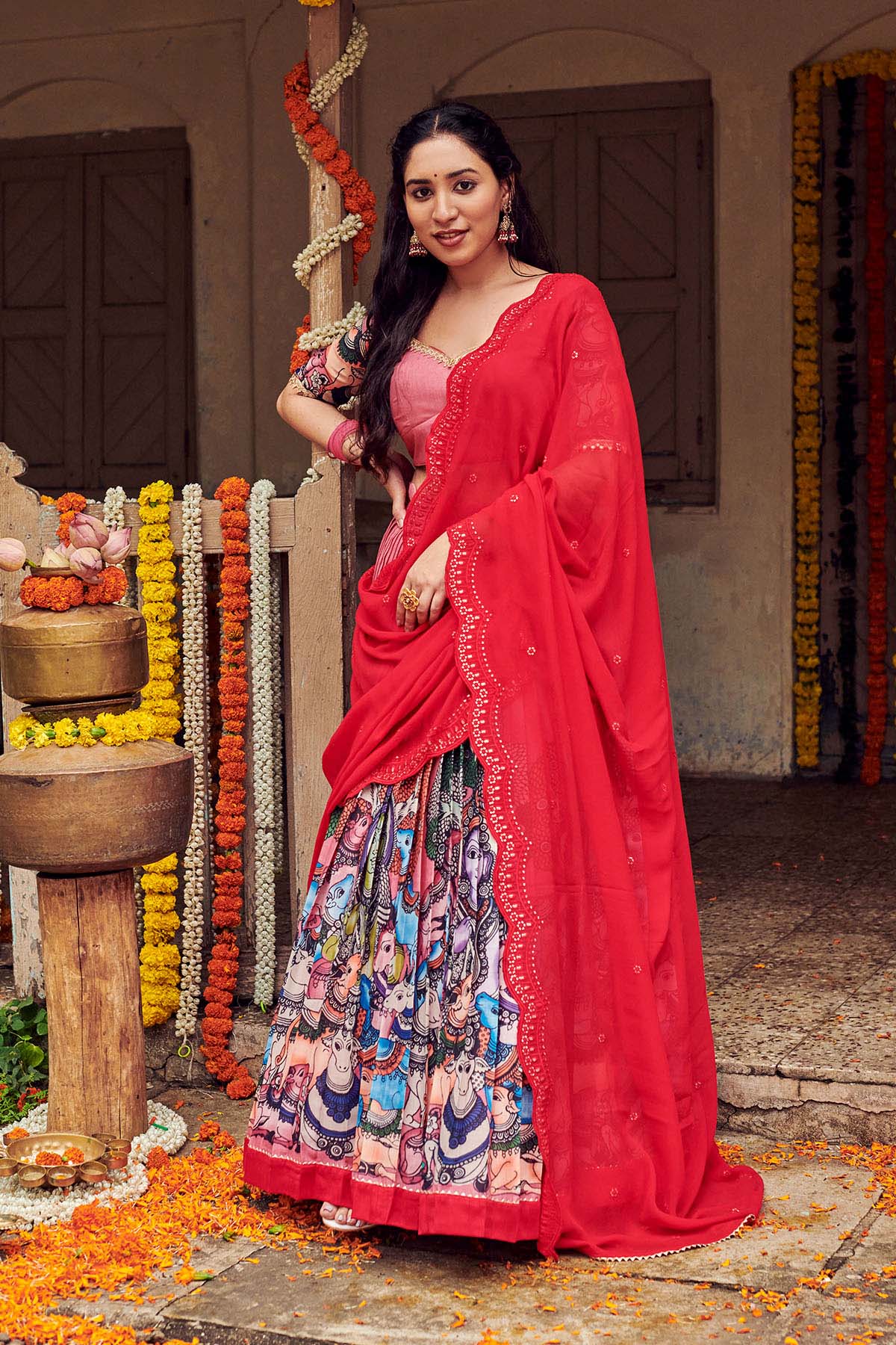 a woman in Red kalamkari lehenga suit