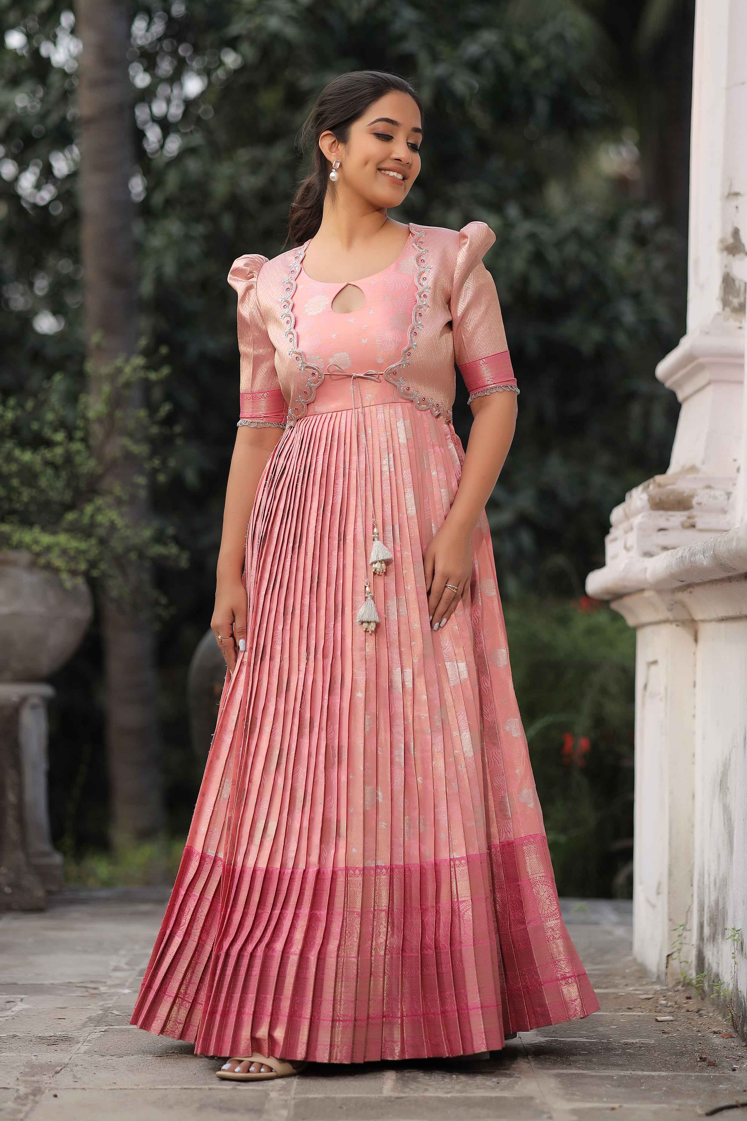 a woman in pink long frock