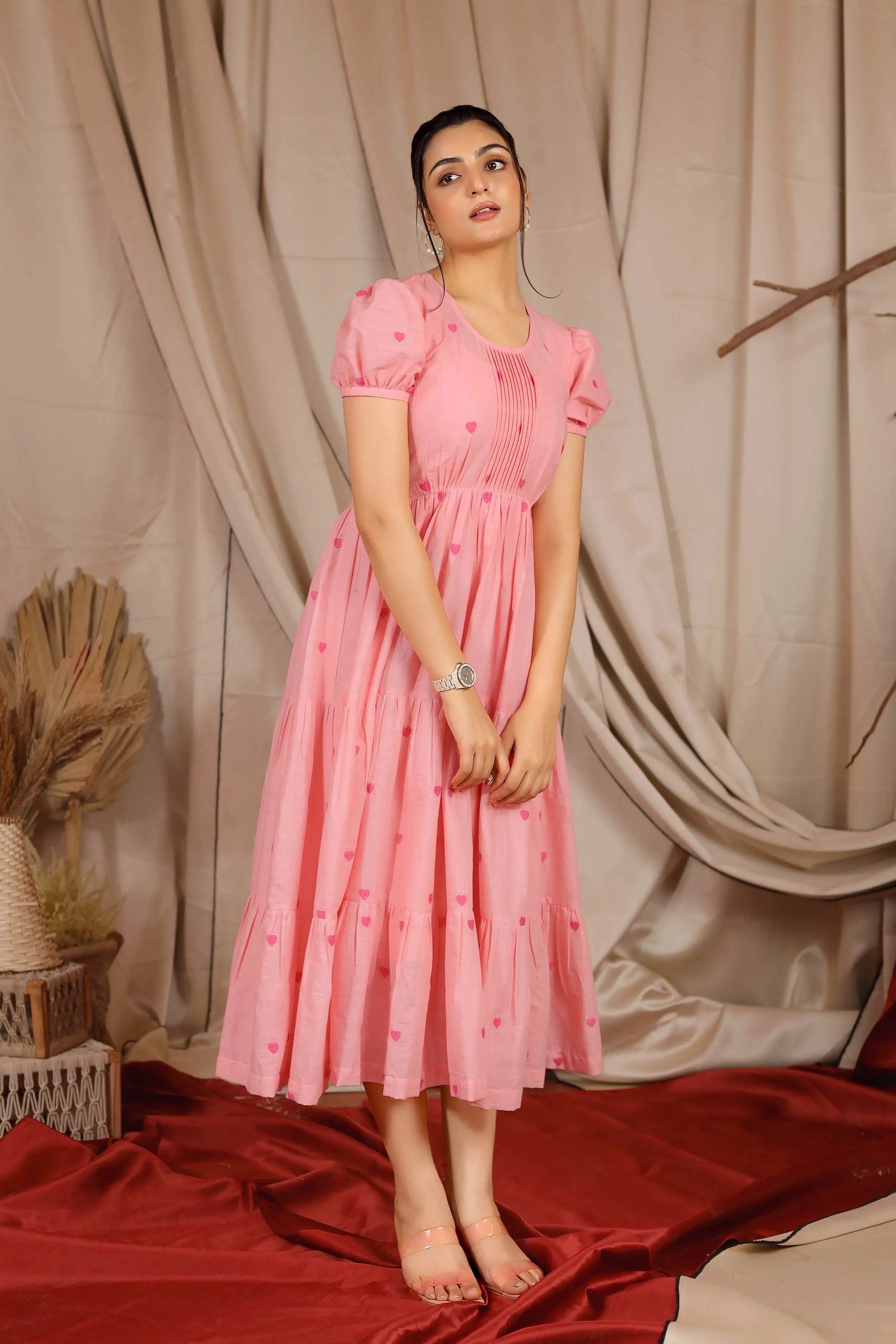a woman in pink cotton midi dress