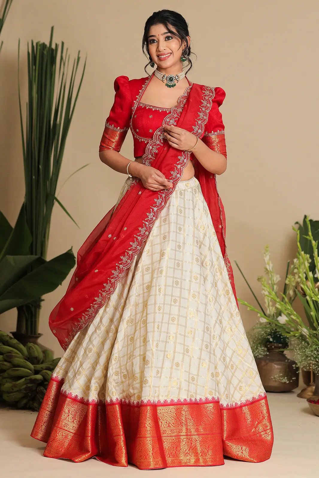 Model in Brindadevi lehenga with red dupatta and blouse