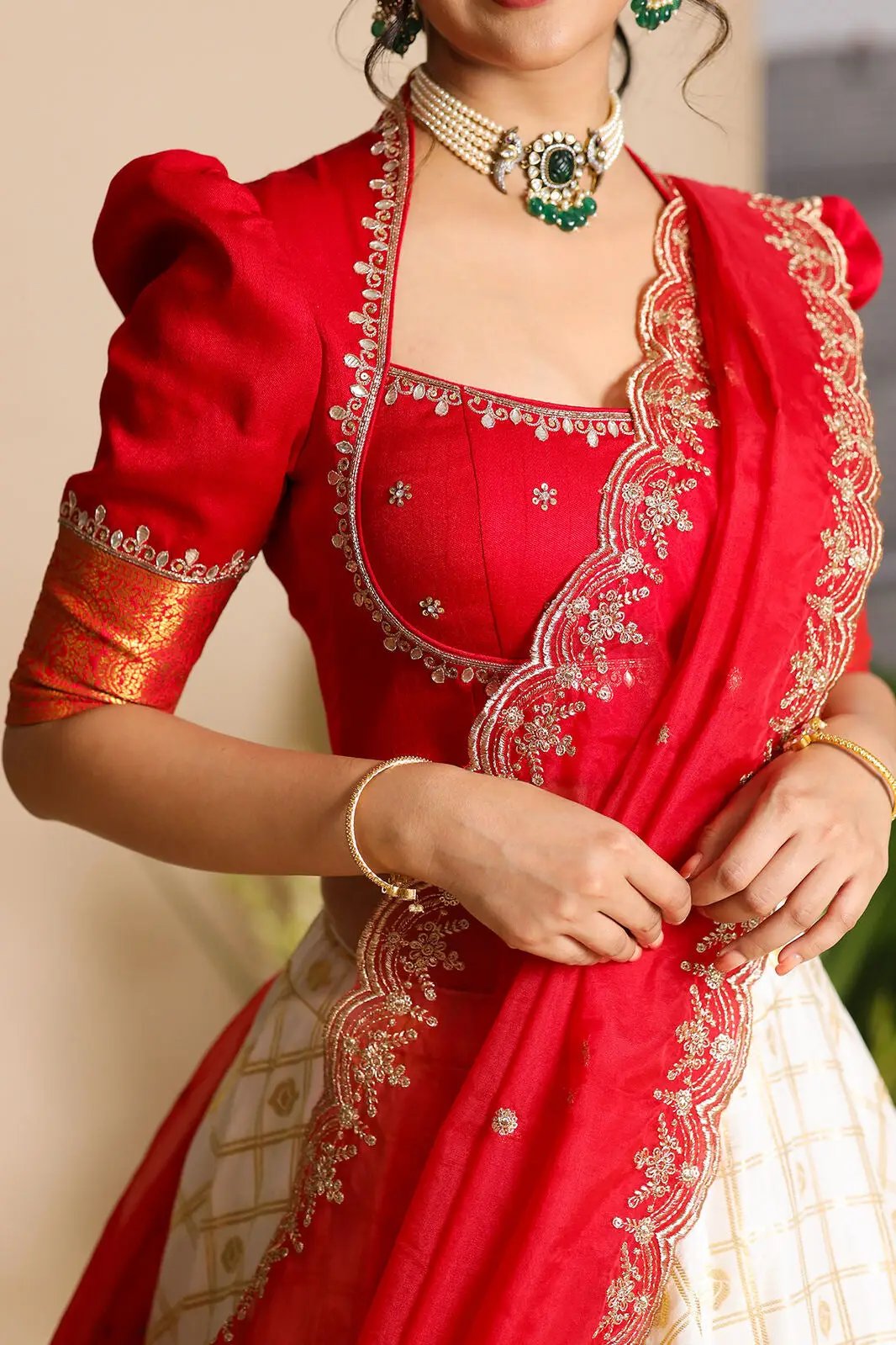 Close-up of red Brindadevi lehenga blouse with embroidery