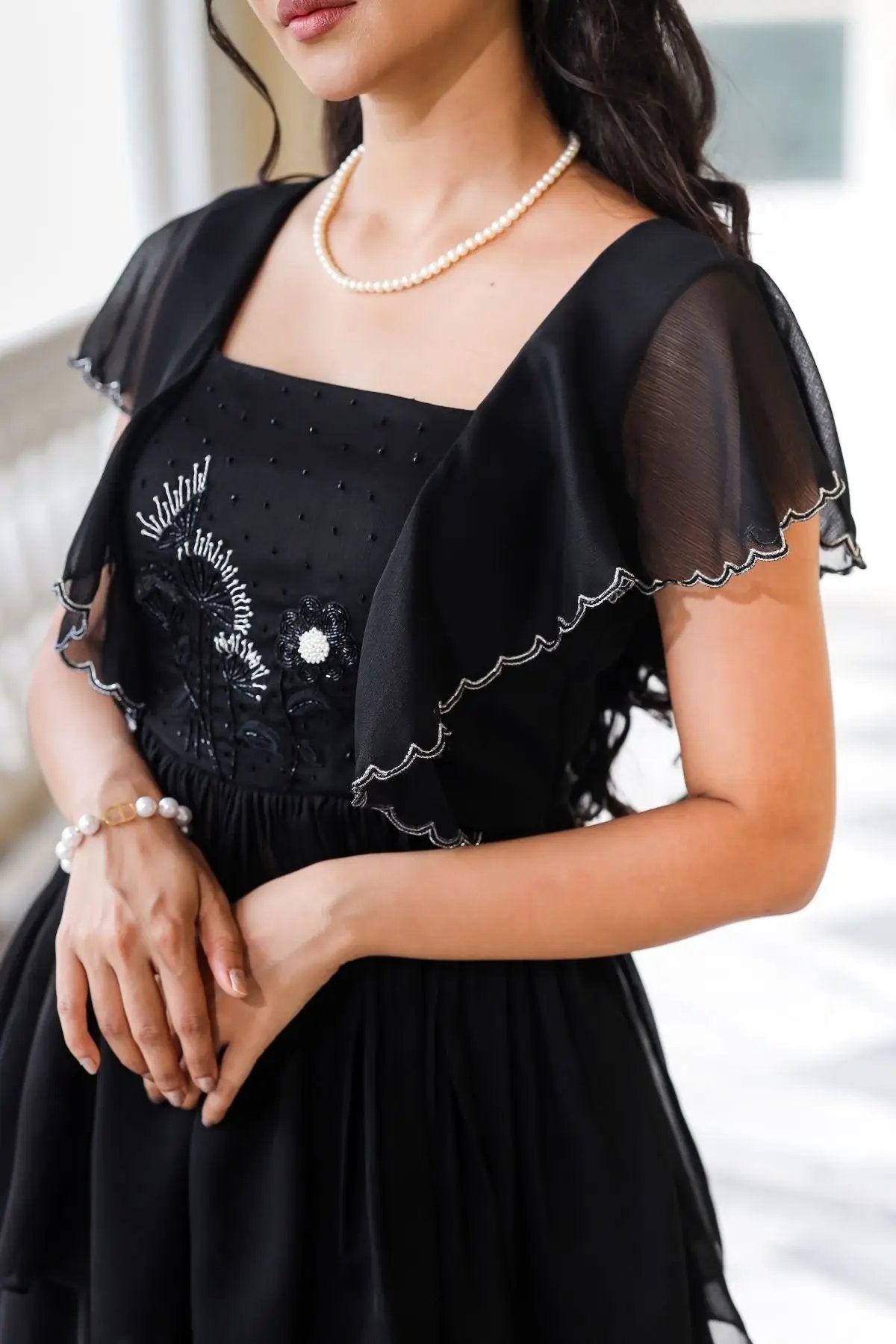 Close-up of Celestial Indo Western ethnic dress in black showcasing delicate embroidery and flutter sleeves, ideal for elegant events.