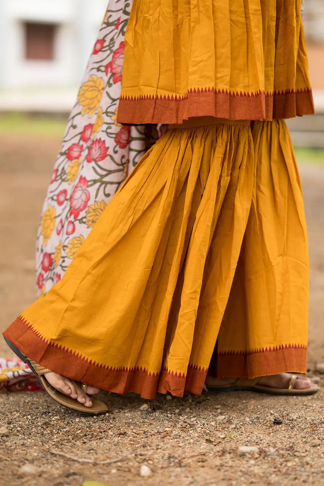 Close-up of Yellow Sharara Set hem and floral dupatta