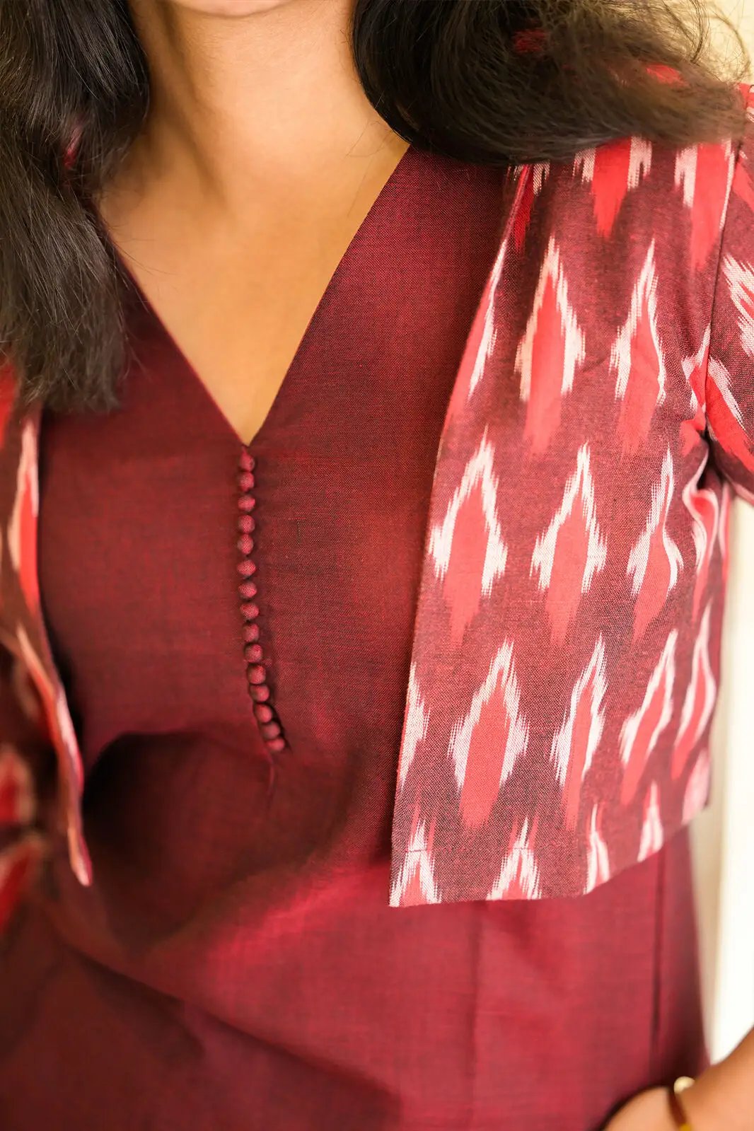 Front view of maroon kurta with patterned jacket